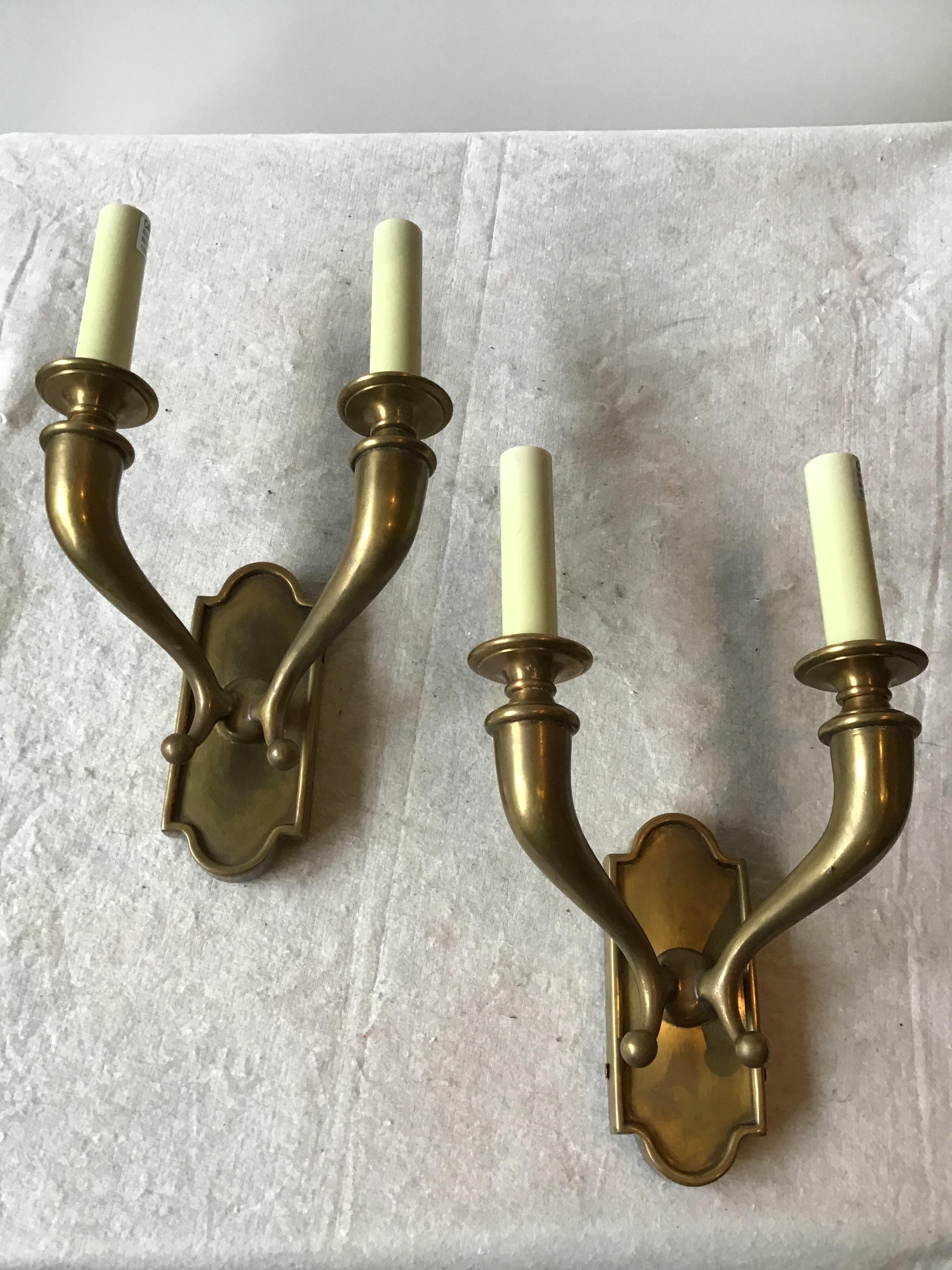 4 solid brass double arm classical sconces out of a Greenwich, Connecticut mansion. Sold in pairs.