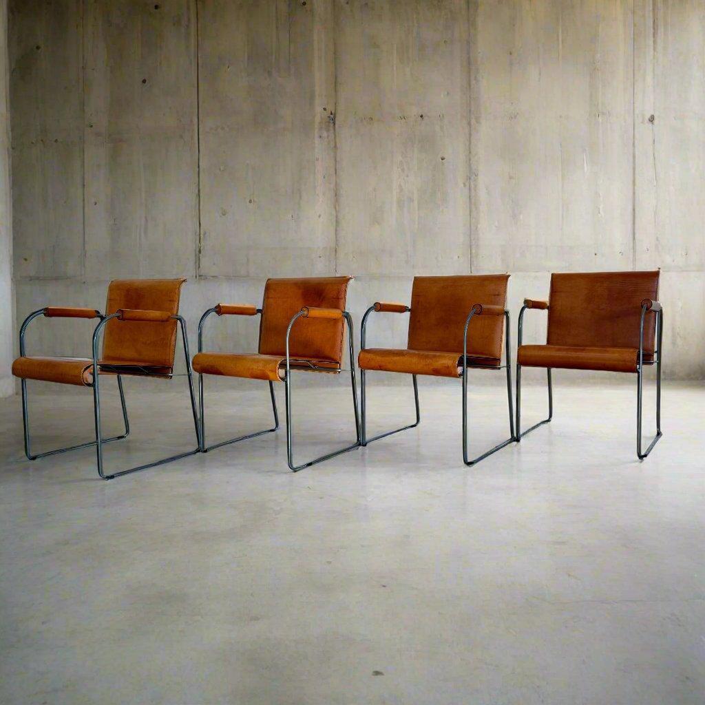 Arrben MOD 131 Camel Brown Leather Dining Chairs – A Timeless Vintage Set

Discover an exceptional set of four Arrben MOD 131 dining chairs, each embodying the elegance of Italian design with a minimalist twist. These chairs, crafted with camel