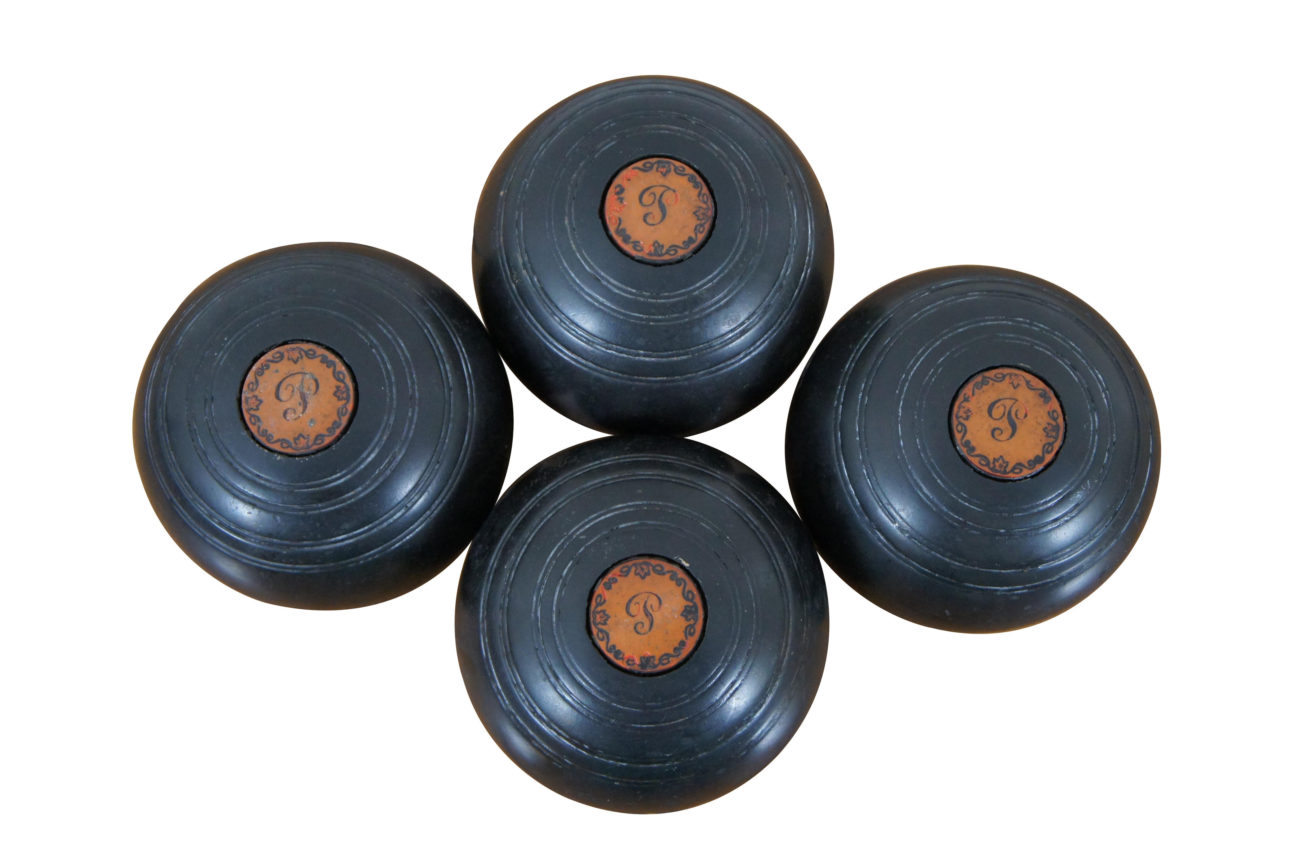 Set of 4 antique Townsend & Clark Champion black lawn bowling bocce balls monogramed with the initial P, surrounded by ivy. Made in Toronto, Canada, 1947. 

Bocce (/ˈbɒtʃi/,[1][2] or /ˈbɒtʃeɪ/,[3] Italian: [ˈbɔttʃe]), sometimes anglicized as bocce