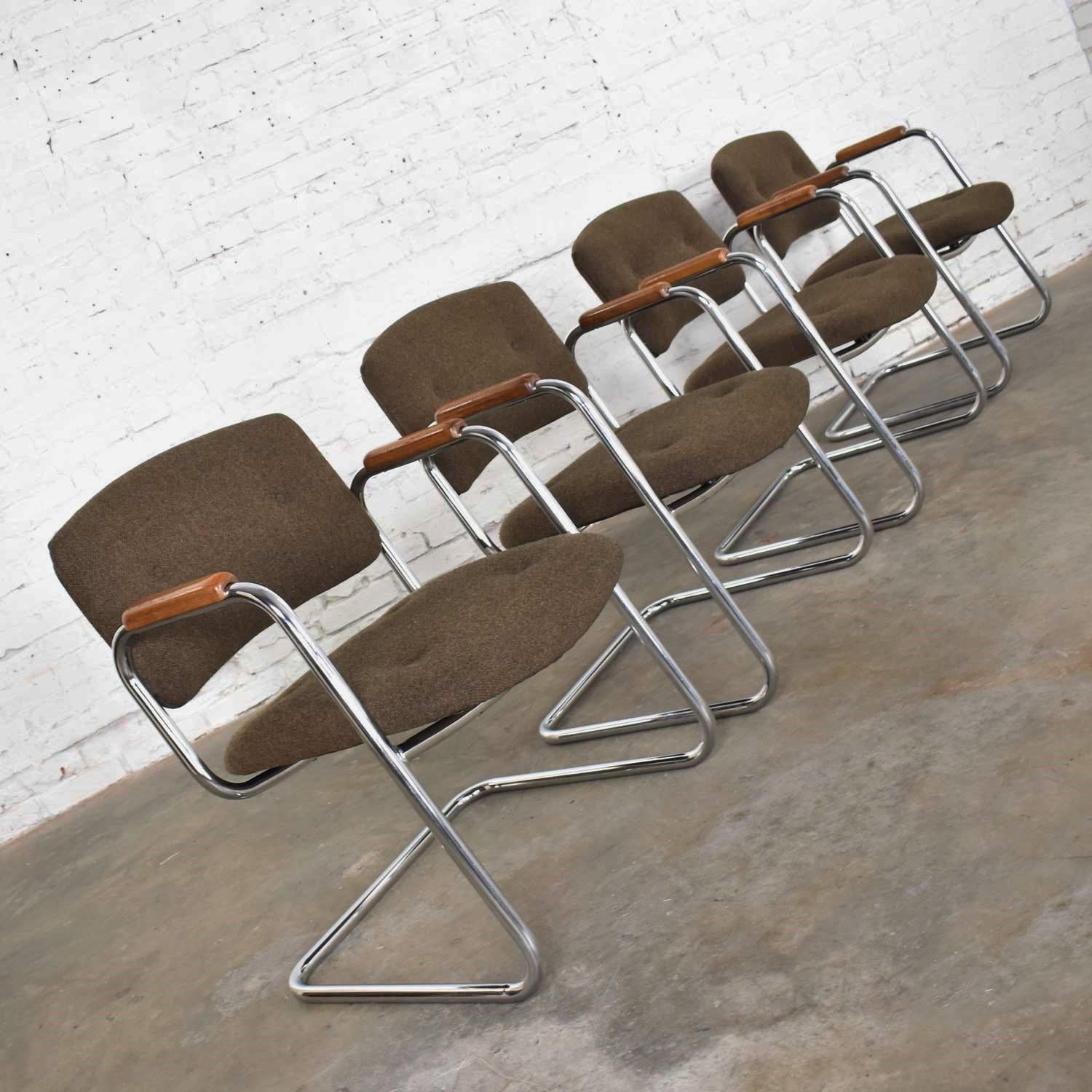 Handsome set of four (4) chrome cantilever armchairs with brown hopsack upholstery and wood arm rests by Delwood Furniture United Chair Division in the style of Steelcase or Charles Pollock. They are in fabulous vintage condition. Their original