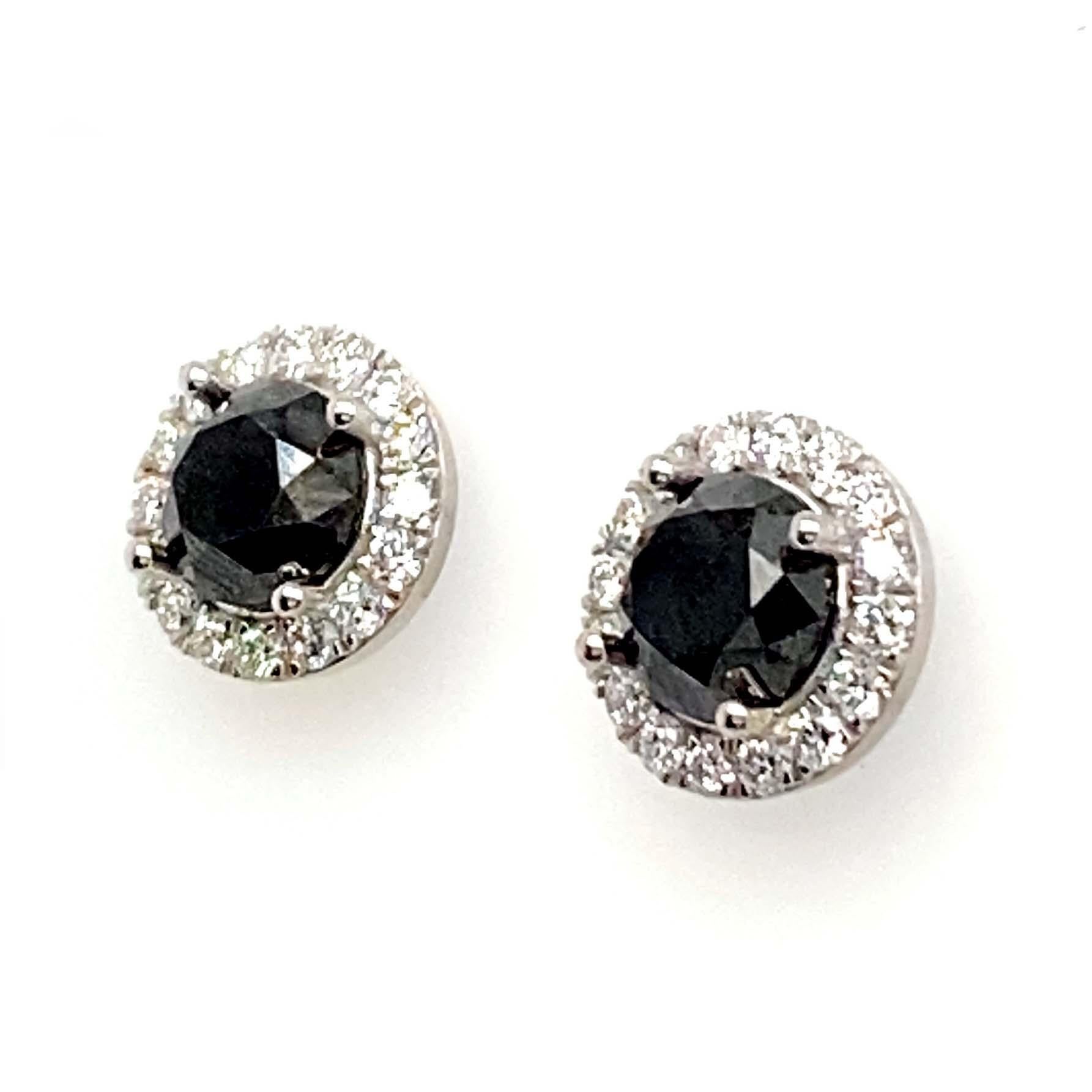 Immaculate black diamond earrings that are accented by white diamonds. These large 4-carat black diamond earring studs can be worn every day or dressed up with other diamond jewelry. Each Black diamond is surrounded by a halo of round-cut diamonds.