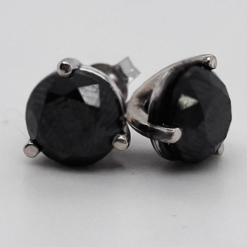 These stunning 14k white gold round black diamond stud earrings provide a look that is both trendy and classic. These diamond earrings are a great staple to add to your collection, and can be worn with both casual and formal wear.  These earrings