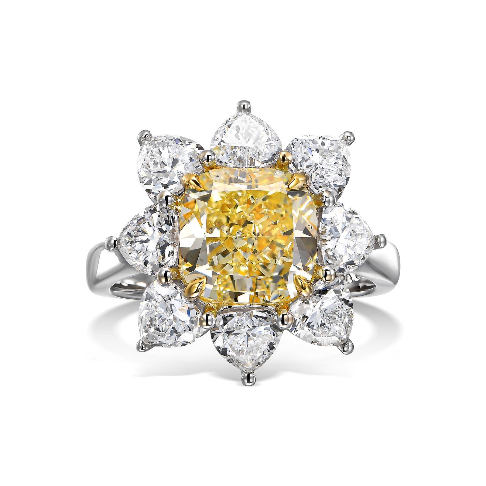 A stunning engagement cocktail ring featuring a 4.10-carat cushion-cut fancy yellow diamond as its centerpiece. This exquisite diamond is gracefully surrounded by a halo of eight colorless heart-shaped diamonds, with a total weight of 2.97 carats,