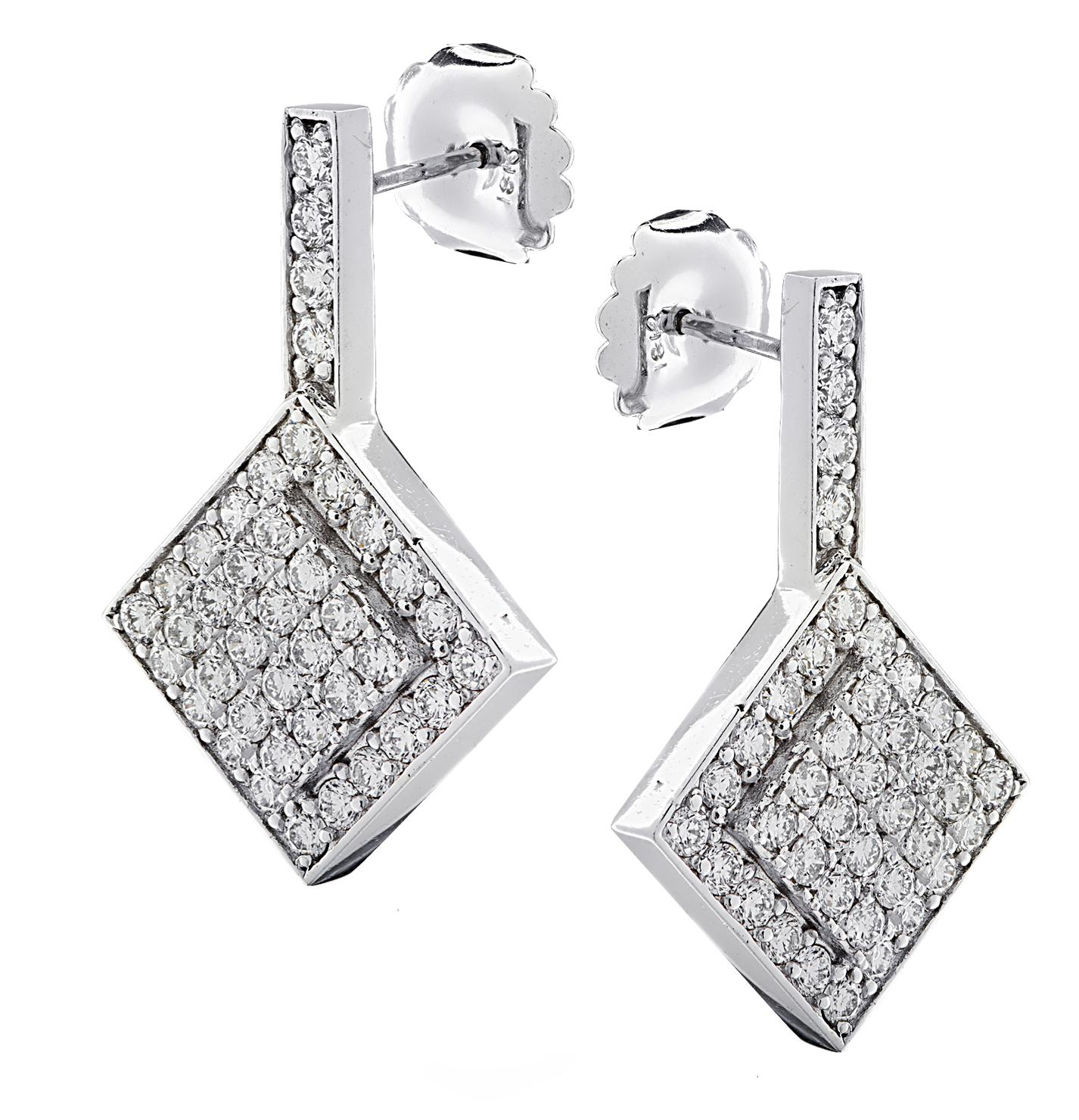 Stunning dangle earrings crafted in 18 karat white gold featuring 88 round brilliant cut diamonds weighing approximately 4 carats total, G color, VS clarity. These striking earrings measure 1.3 inches in length and .84 of an inch at their widest