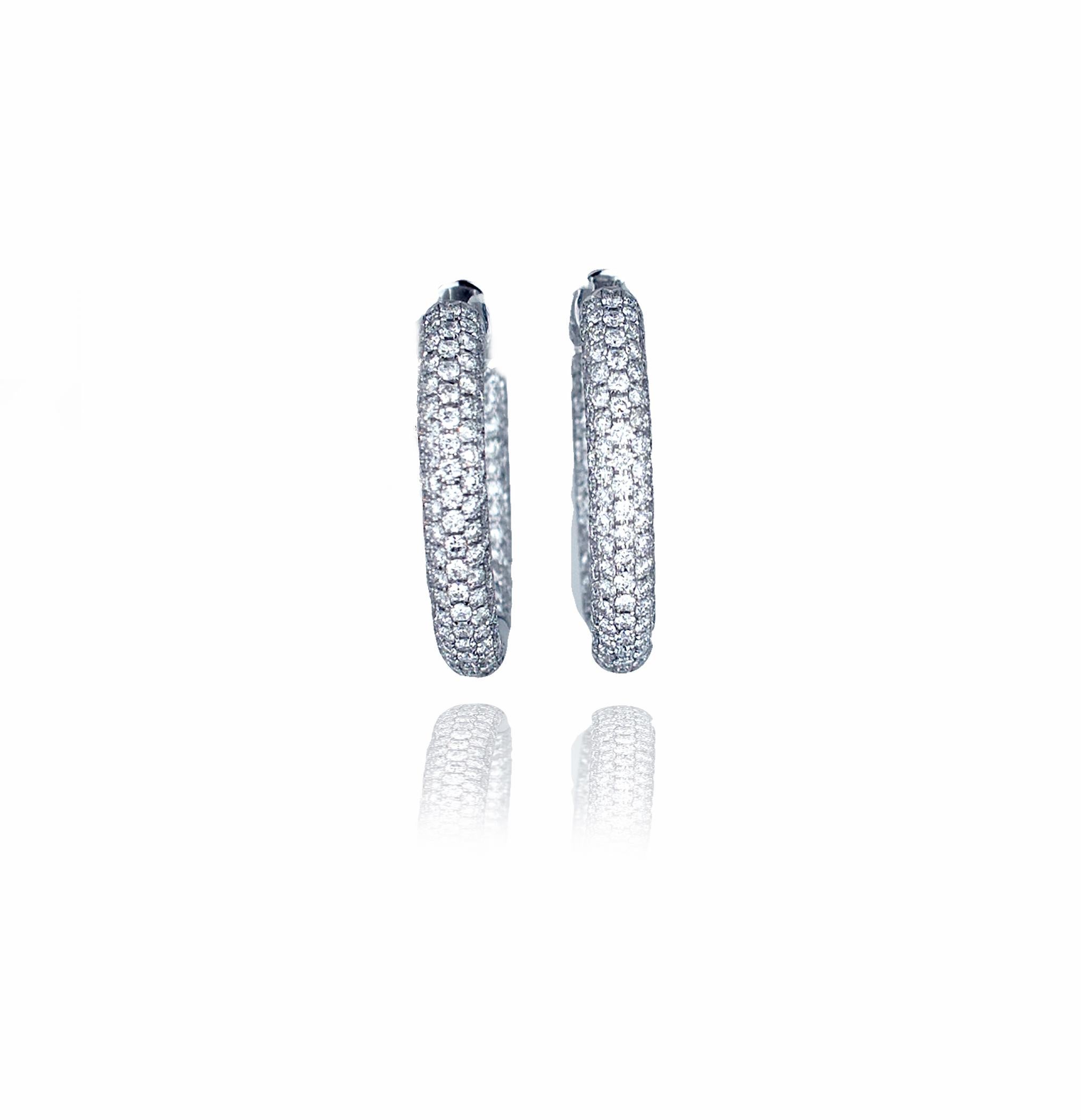 These classic modern hoops came out of an estate in Northern California and have a white G-H SI color and clarity diamonds set in 18k white gold.  The earrings have a gorgeous hinged system that is hidden giving the wearer just diamonds to be seen. 