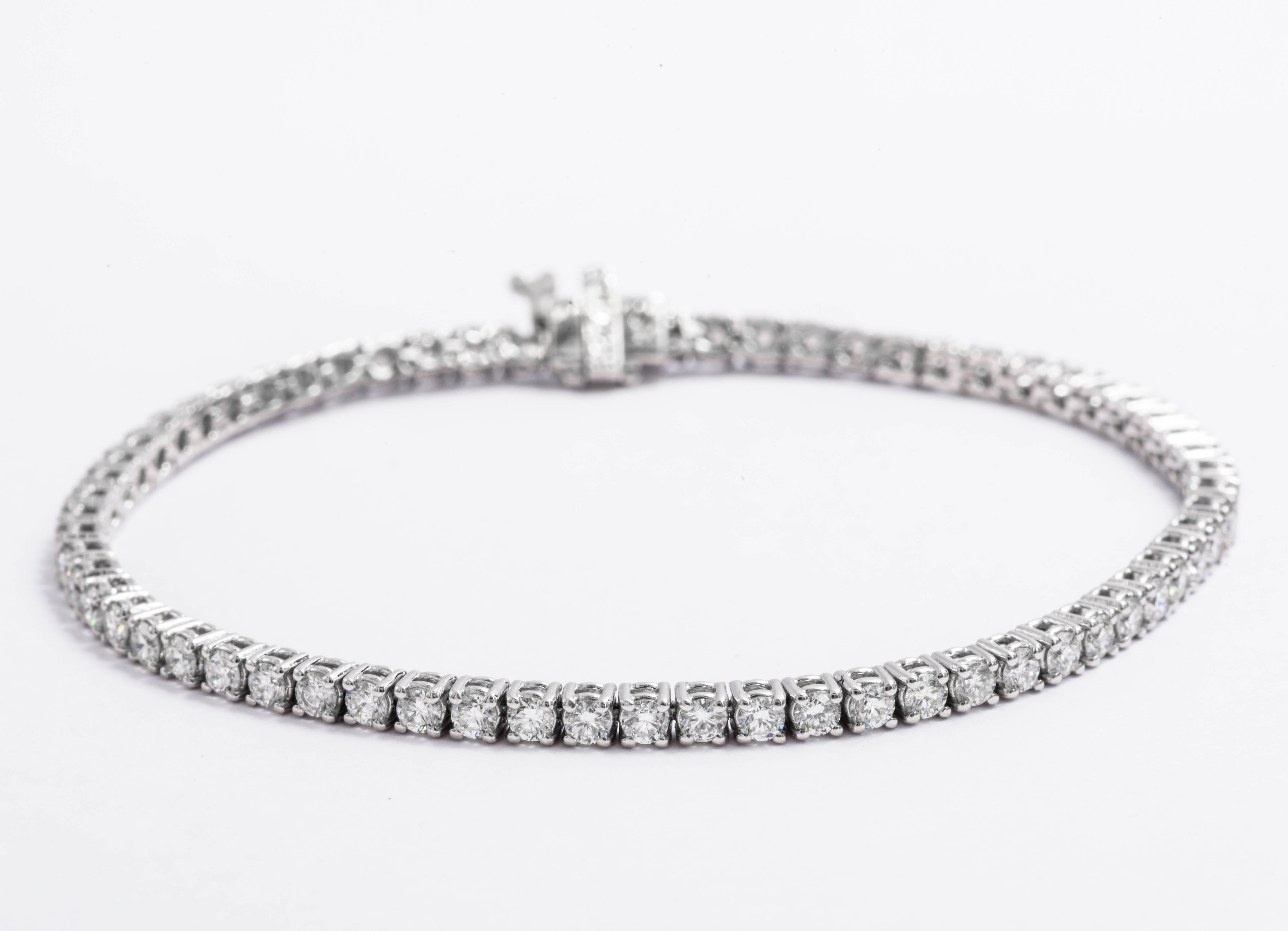 14 Karat White Gold diamond tennis bracelet featuring 57 round brilliants weighing 4 Carats.
Color G-H
Clarity SI

Can be made in 18 Karat White Gold or Yellow Gold
DM for pricing.

In stock 1-22 Carat Tennis bracelets.