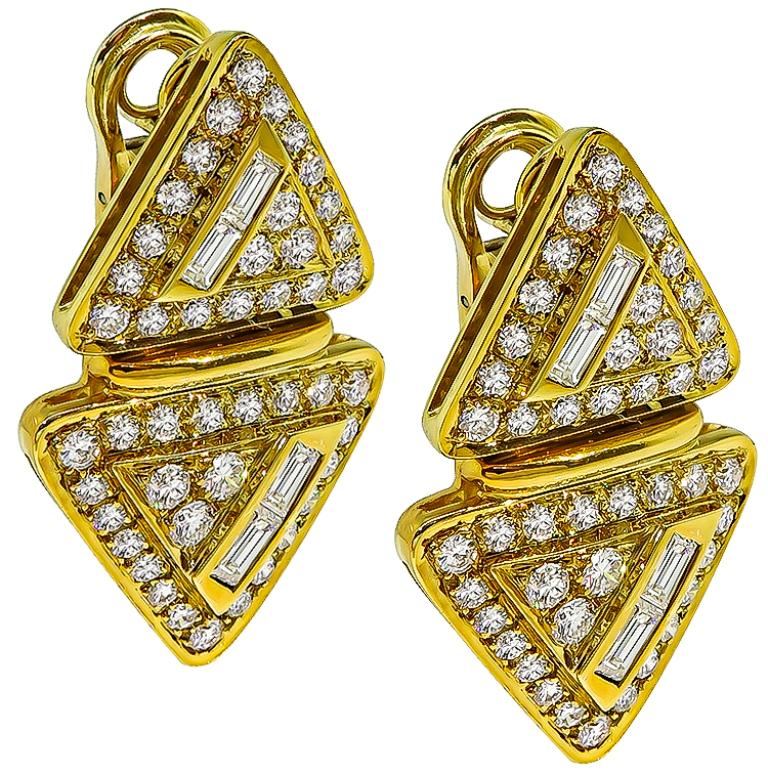 This gorgeous pair of 18k yellow gold earrings feature sparkling baguette and round cut diamonds that weigh approximately 4.00ct. graded G color with VS clarity. The earrings measure 37mm by 22mm and weigh 23.2 grams.
They are stamped 750.
Inventory