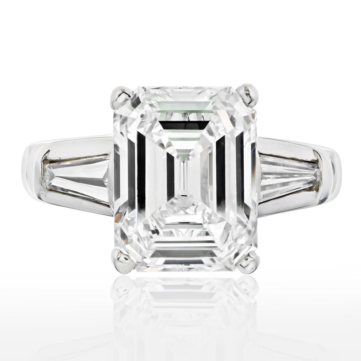 Stunning ring when you want to show up! Mounted with an impressive 4 carat Emerald Cut Diamond that is mounted in platinum accented by baguette cuts. 
The Center diamond is a certified K/VS2 GIA stone. 
Three-stone diamond engagement rings have