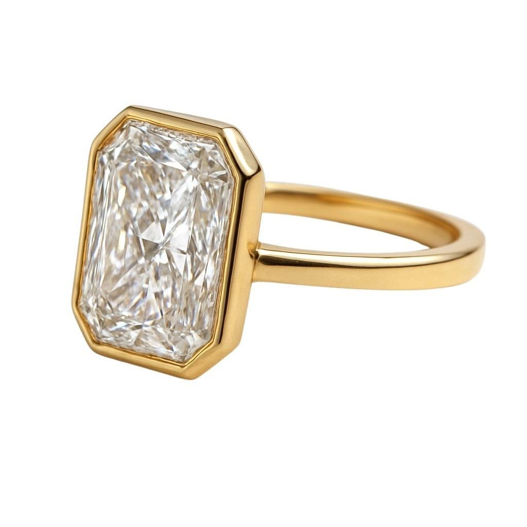 Timeless elegance meets contemporary design in this stunning solitaire ring, crafted in rich 18K yellow gold. The centerpiece is a breathtaking 4.01 carat GIA-certified diamond, featuring a cut-cornered rectangular modified brilliant cut, set in a