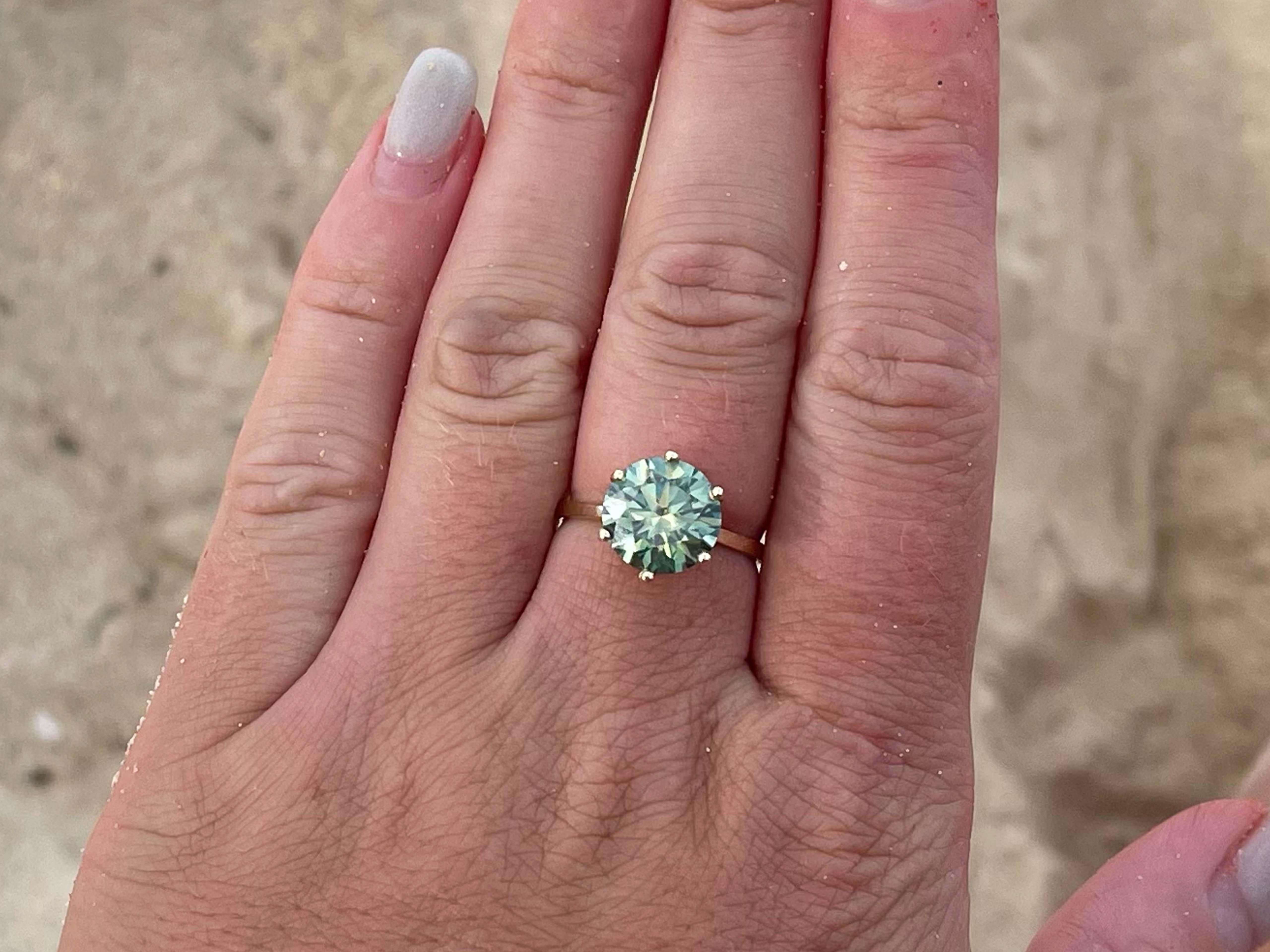 Item Specifications:

Metal: 14K Yellow Gold

Total Weight: 2.3 Grams
​
​Ring Size: 7

Moissanite Carat Weight: ~0.60 Carat

Moissanite Color: Fancy intense green

Moissanite Clarity: VS1

Condition: Preowned, excellent
​
​Stamped: 