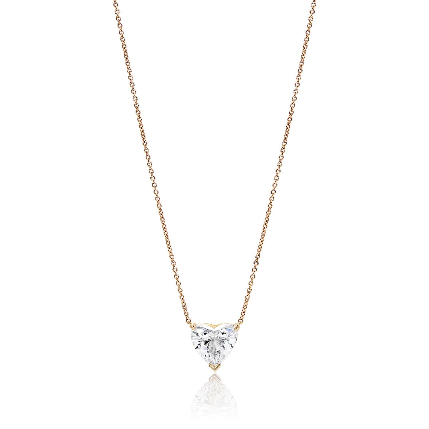 This luxurious piece features a 4.14 carat diamond, mined from the earth and cut into a stunning heart shape. It sparkles with a natural brilliance and fire that is truly captivating. The color is a clean, translucent white with a slight yellow hue.
