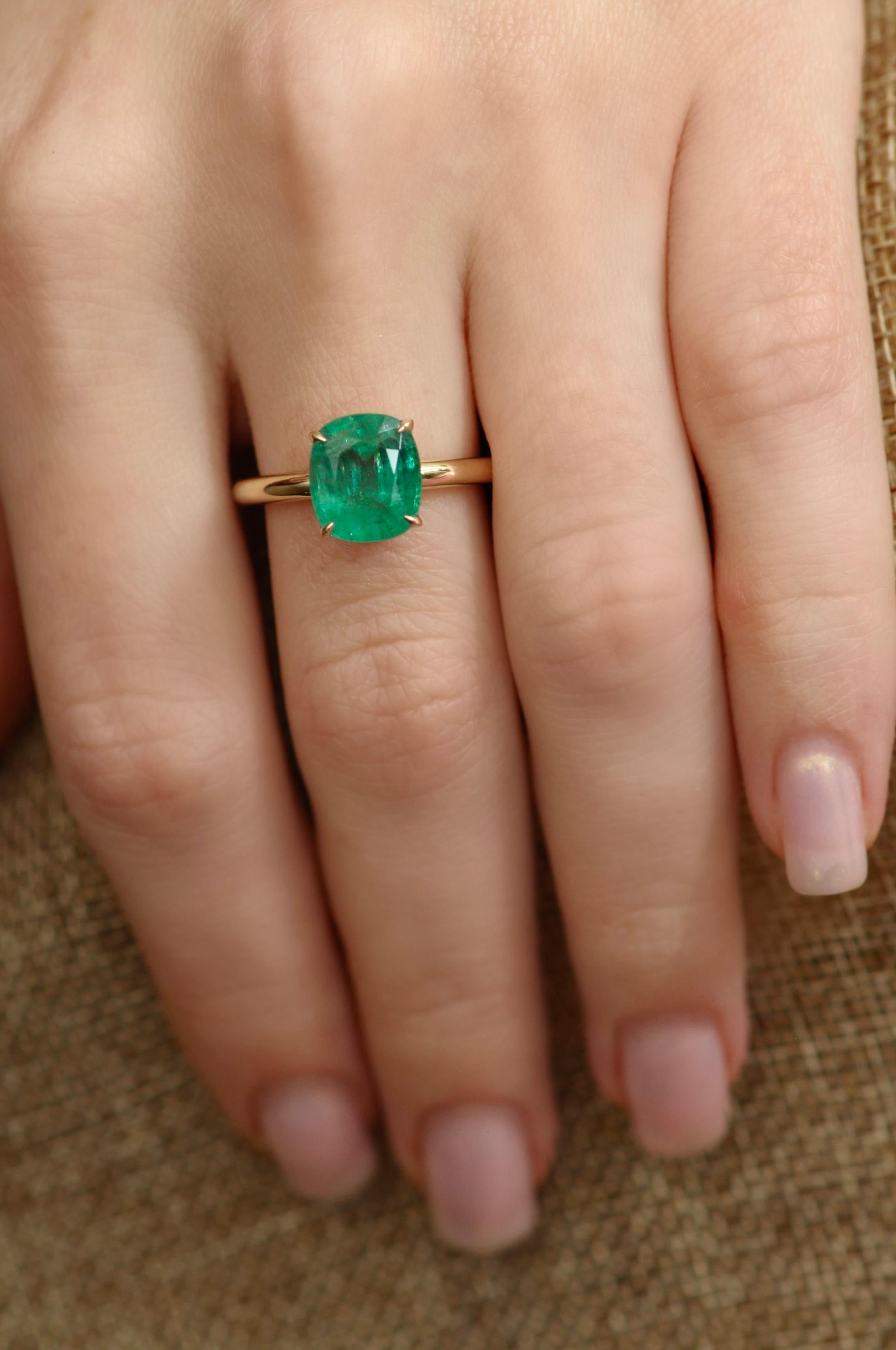 This is very elegant ring with 4 carat emerald. 
We chose a minimalistic design for this casual emerald ring - the main focus is on the stone and gold is just a frame to make it modern and fashionable. 
The emerald has very grassy color, Zambian