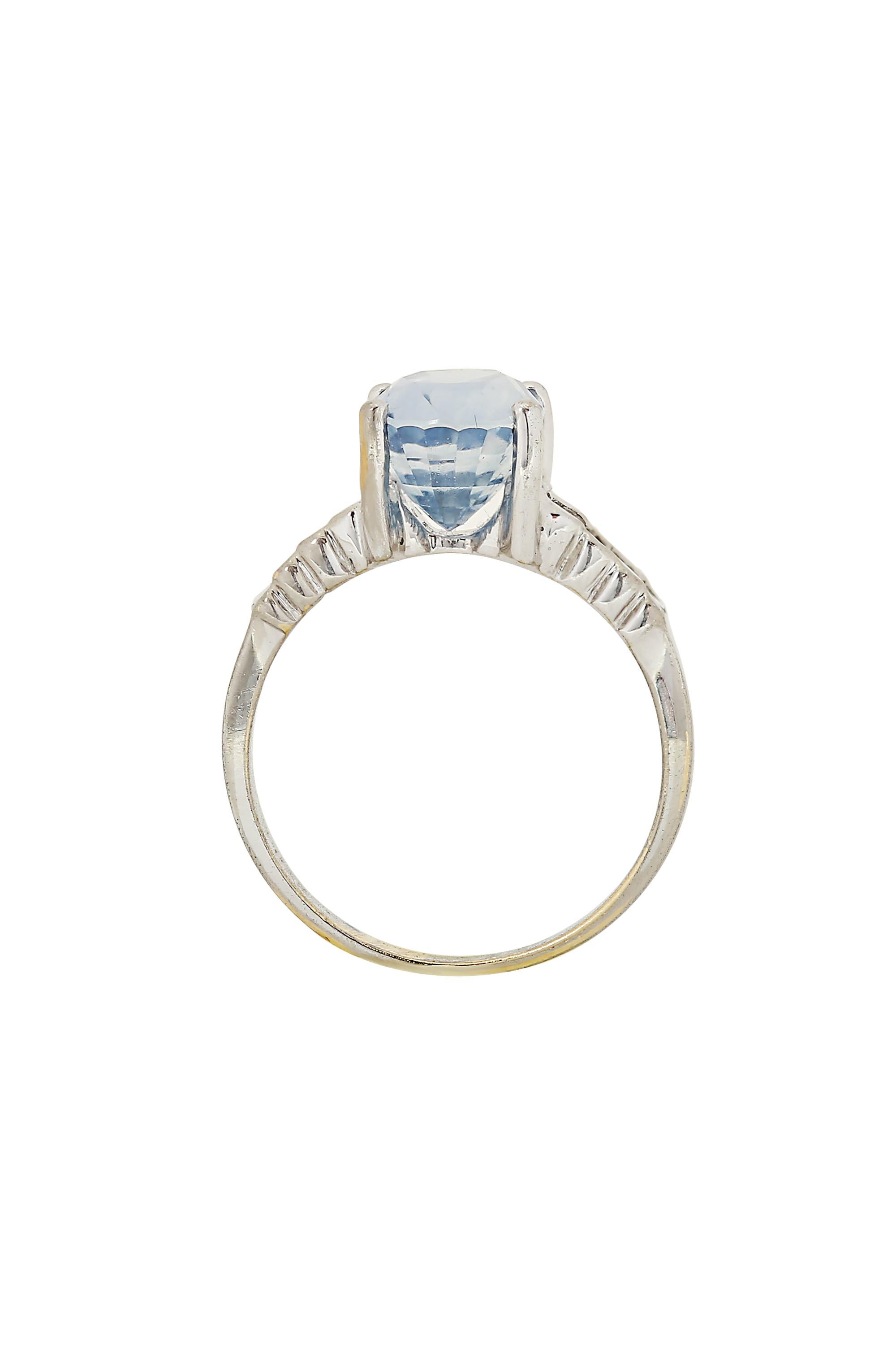 This ring features a delicately hued lavender fancy cut oval sapphire accentuated by shoulders of baguette cut diamonds in a 14 karat white gold mounting. The lavender sapphire weighs approximately 4 carats and is unheated. Currently a size 7 and