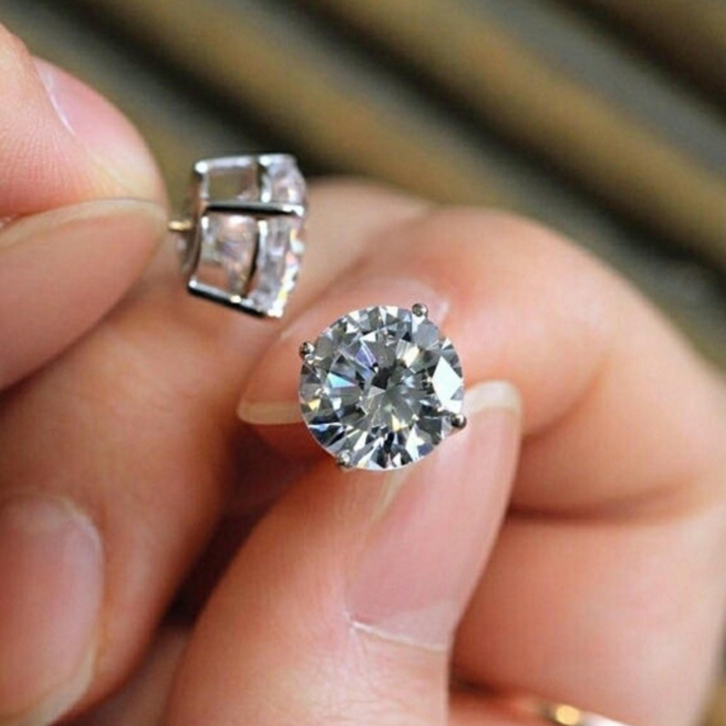 4.15ctw pair of round brilliant cut natural diamonds offer fantastic size, bright white color, and a lively play of light! Measuring 8.1mm in diameter, the diamonds have a great spread and a larger than typical look for their weight! They are 100%