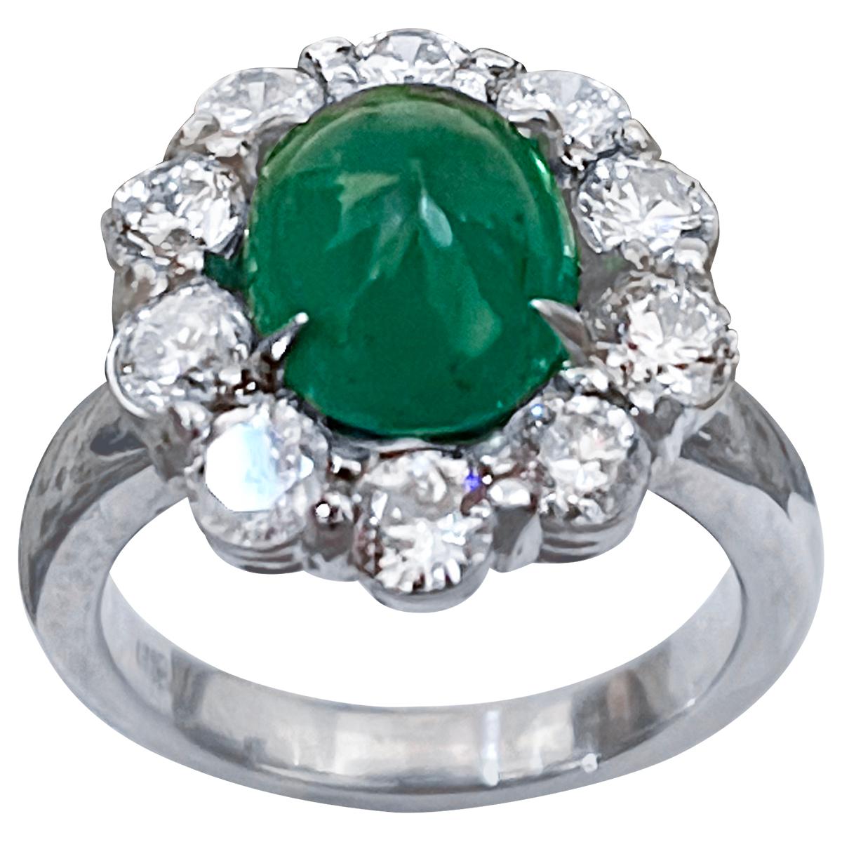 4 Carat Natural Oval Emerald Cabochon & Diamond Ring 18 Karat White  Gold Size 6
A classic, Cocktail ring 
10 X 12 Oval Cut  Emerald Cabochon, 
Origin Zambia
Oval Shape  Emerald Ring 
Very clean and intense green color .
Brilliant cut round diamonds