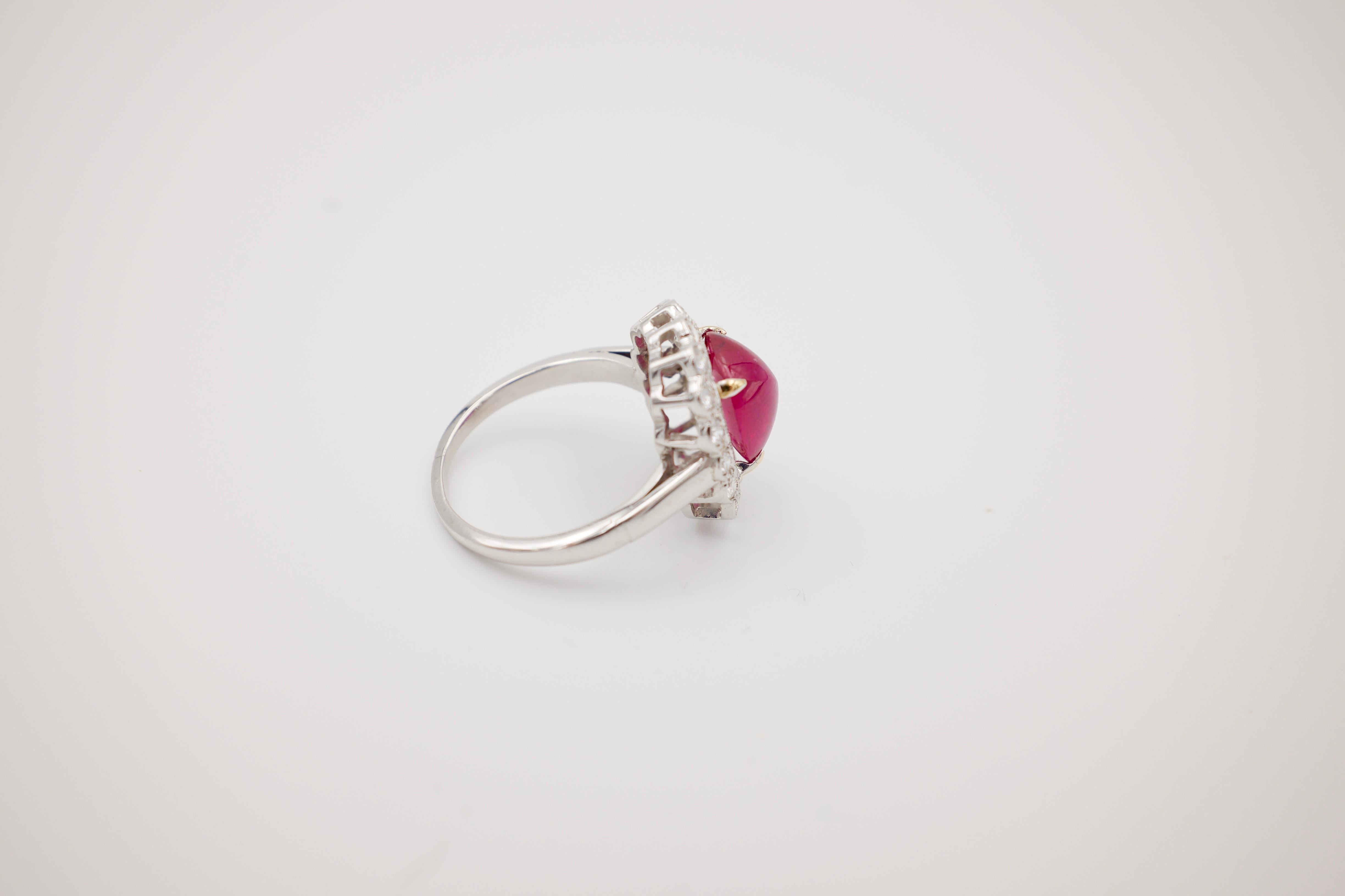 A bright no heat ruby surrounded by approximately 1 carat of old cut round diamonds.  Ring is gorgeous.  Sizable from current size: 7.  