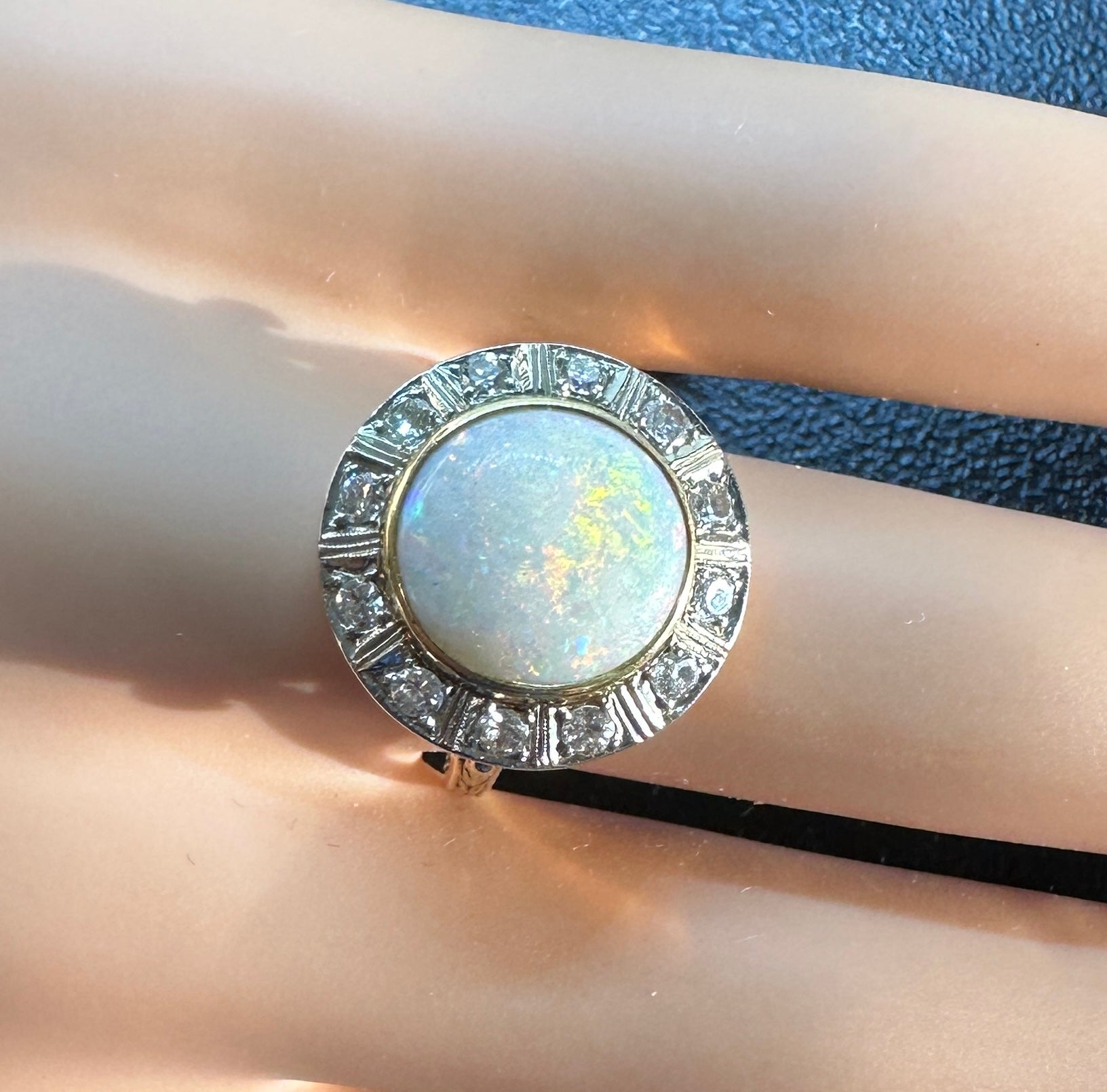 This is one of the most beautiful Antique Victorian to Art Deco 4 Carat Opal and Old Mine Cut Diamond Halo Rings we have seen.  The ring is 14 Karat Yellow Gold and the Diamonds are set in Platinum or White Gold.  The extraordinary round cabochon