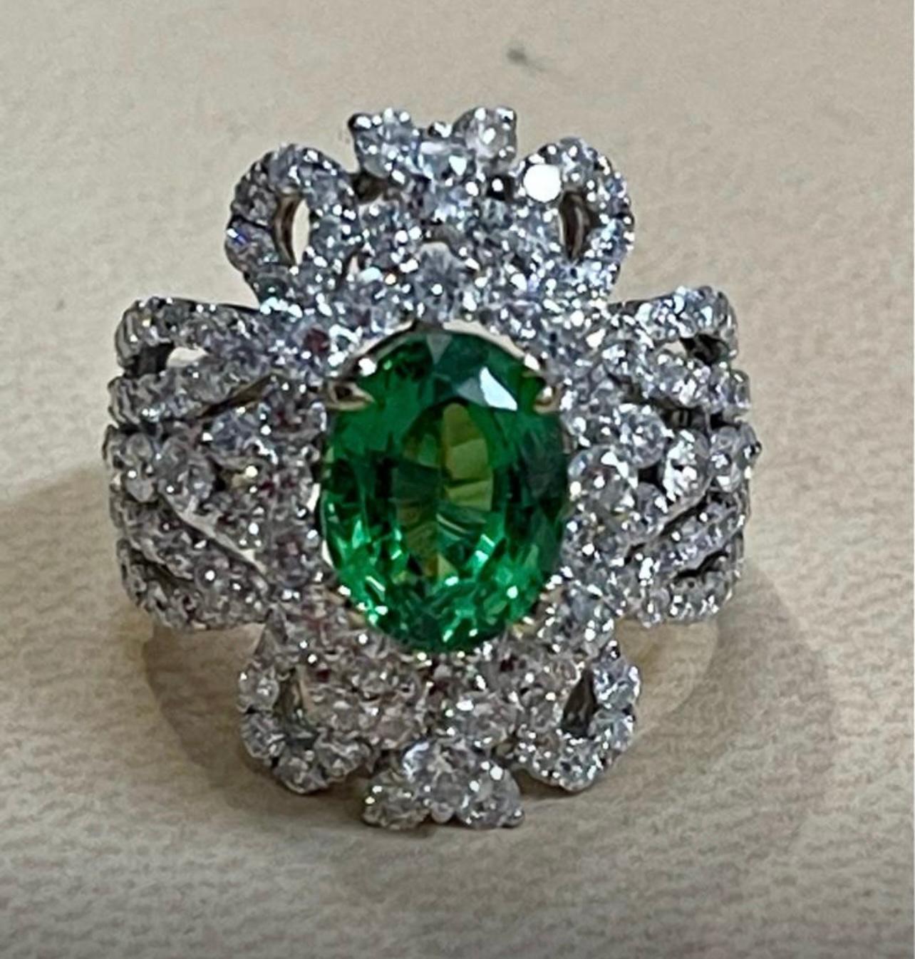 Approximately 4 Carat Oval Tsavorite and 2.9  Carat Diamond in 18 Karat White Gold Ring Estate Size 6.5
Tsavorite of this size are very precious!
Approximately 4 Carat   Oval cut Tsavorite and Diamond Ring, Estate with no color enhancement.
Gold: 18