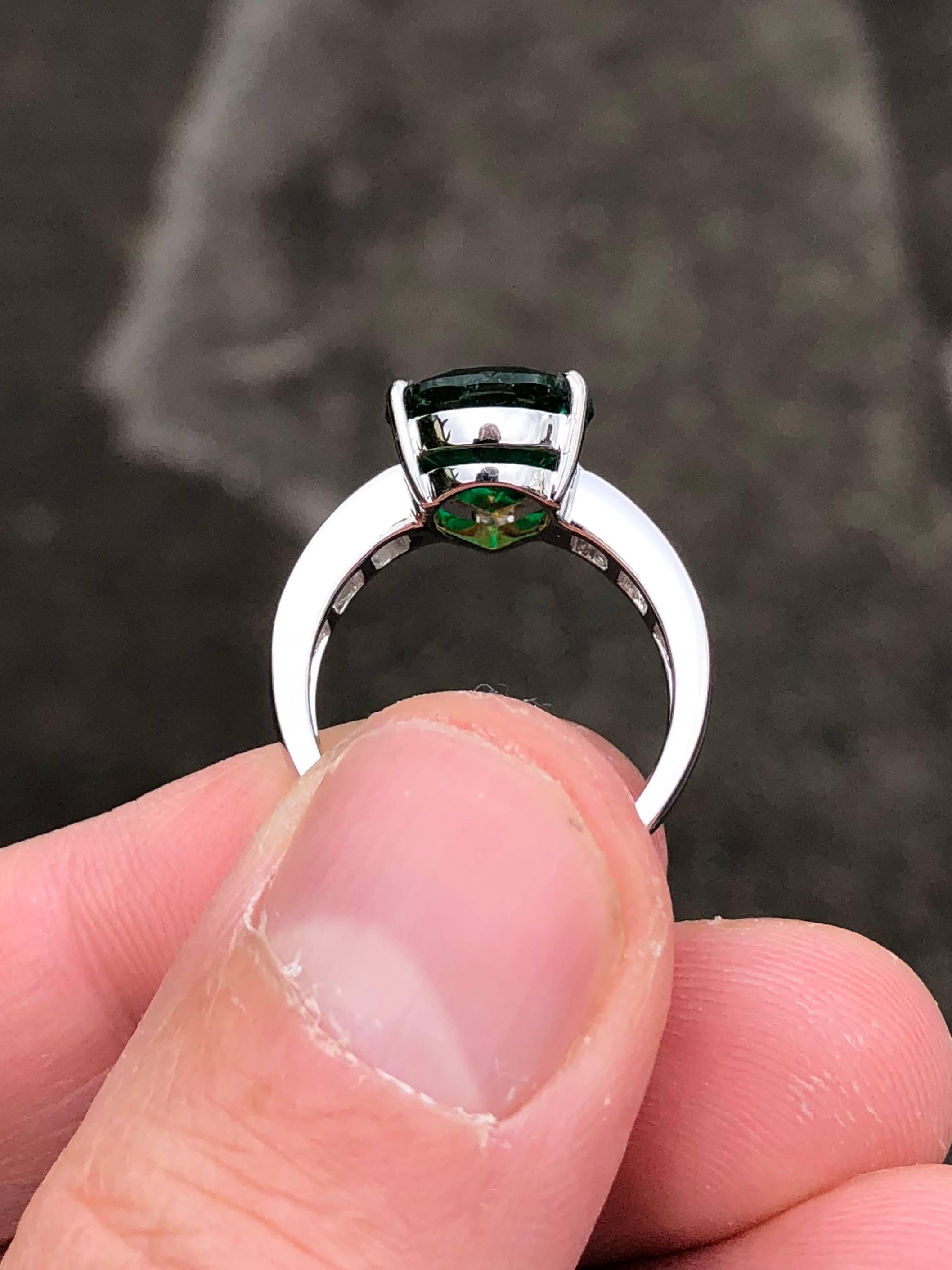 The centre stone of the ring is a beautiful 4 carat, fine Muzo Colombian emerald, certified by Gübelin Gem Lab, Lucerne, Switzerland. This piece is decorated with certified E colour, baguette cut diamonds and set in 18K white gold.