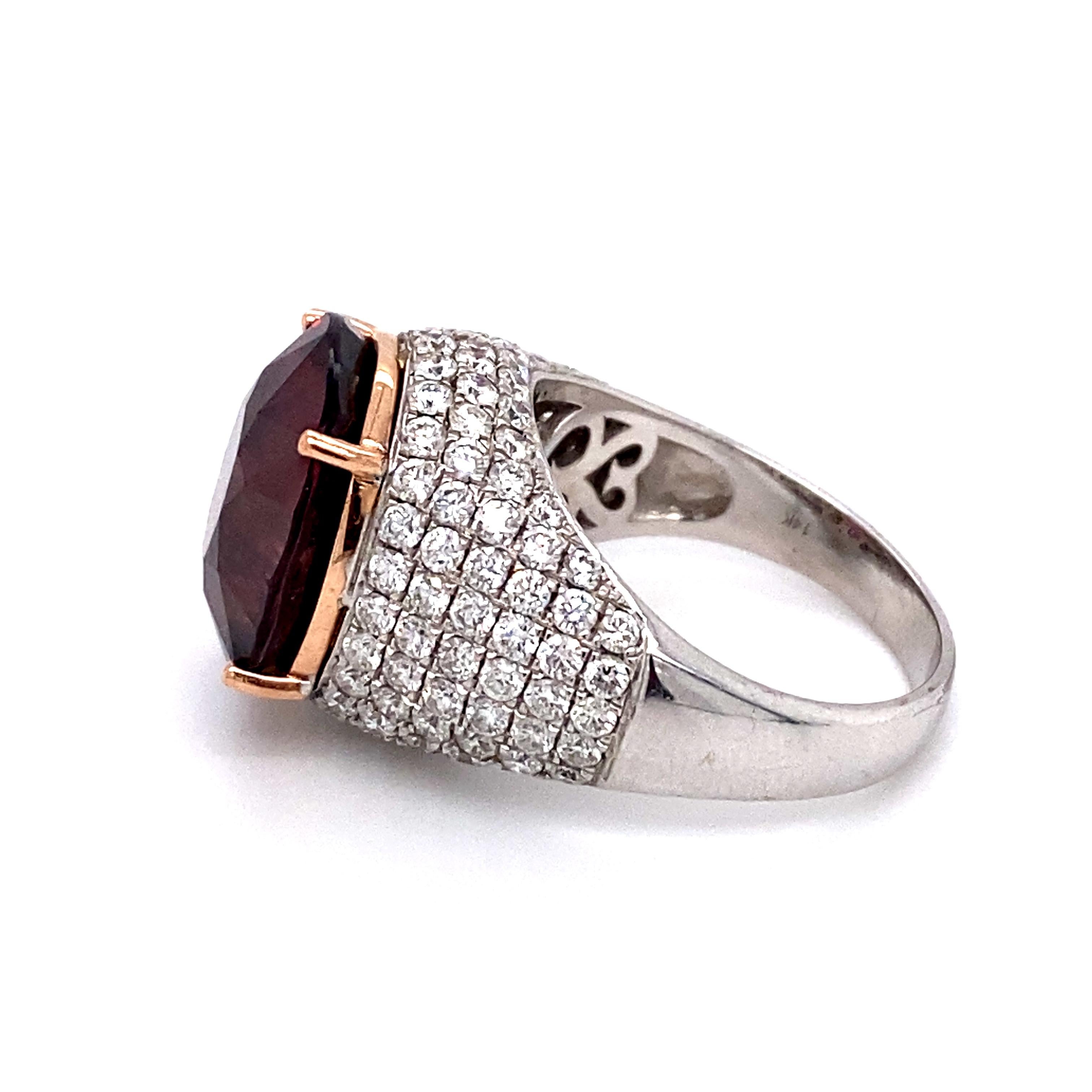 Circa: 1980s
Metal Type: 14 Karat White Gold and Rose Gold
Weight: 9.9g
Size: US 7.25, resizable

Tourmaline Center Stone Details: 
Carat: 4 carats 
Color: pinkish purple 
Cut: Oval
Measurement: 14.4 millimeters x 12.5 millimeters 

Diamond Details: