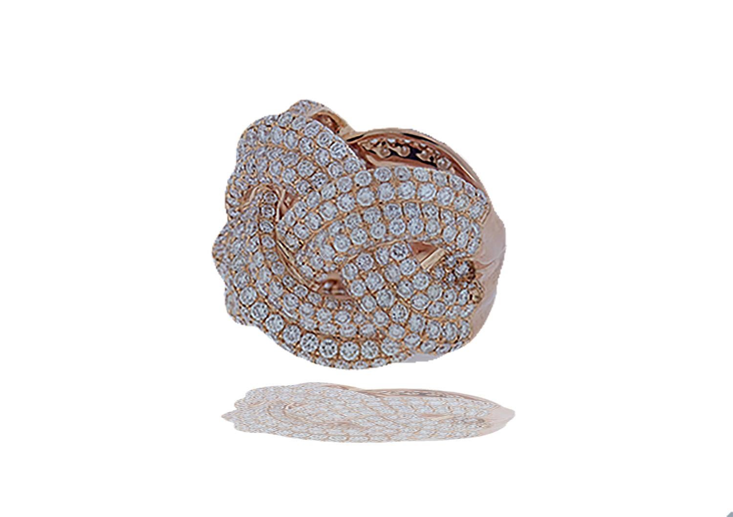 Curved lines and sweeping lines of pave' diamonds can be seen in this gorgeous 18k rose gold ring.  The three row braid is expertly set and crafted with over 4 carats of white round brilliant diamonds that exhibit a color and clarity of E-F VS.  The