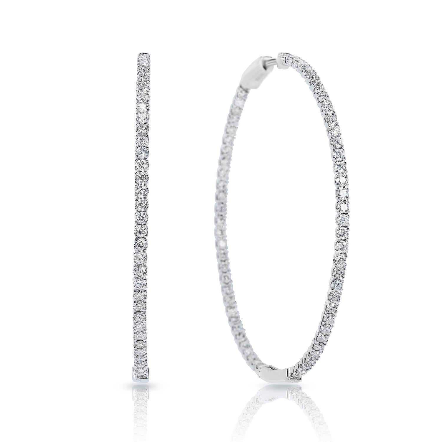 Diamond Hoop Earrings:

Carat Weight: 3.75 Carats
Shape: Round Brilliant Cut
Metal: 14 Karat White Gold
Style: Hoop Earrings