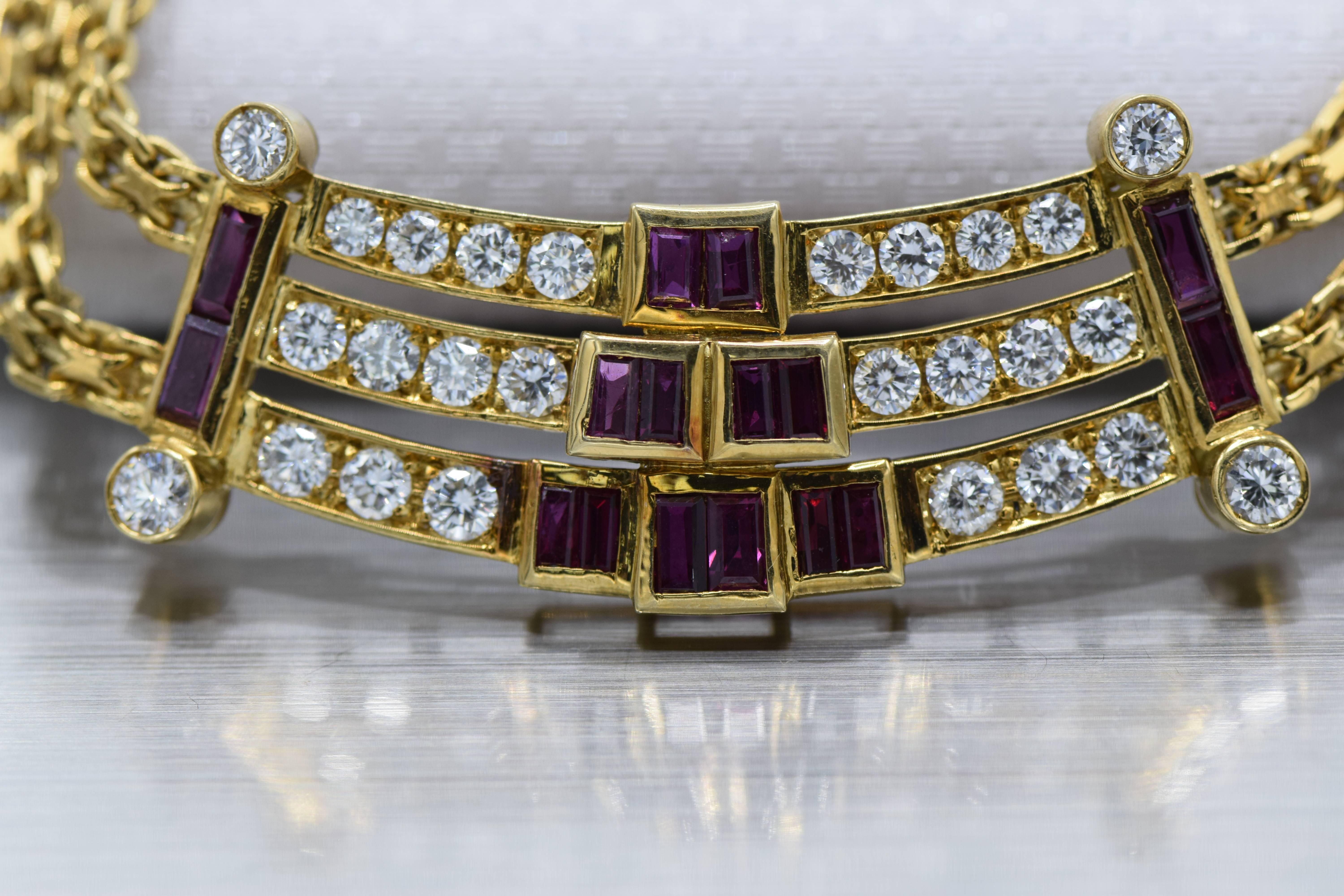 The front plaque with three curved round diamond channels accented by graduated rectangular rubies, joined to a twin fancy linking back chain gathered by ruby and diamond stations, mounted in 18k gold, 

length 14 1/2 inches

Diamonds: 34 round