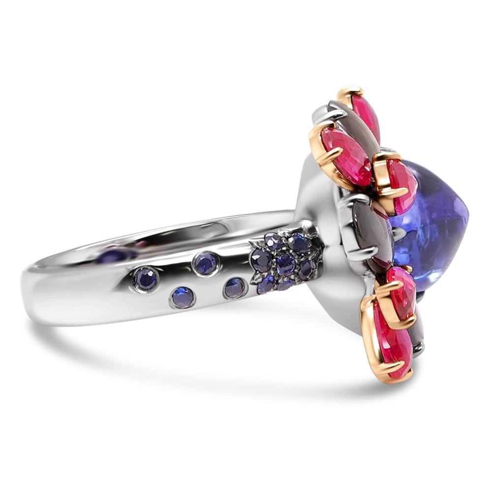 A 4.43 carat Tanzanite Sugar Loaf is set alongside 1.73 carat of Sapphire and 1.18 carat of Ruby. 0.52 carat of round sapphire are set in this 18K gold colorful ring.
