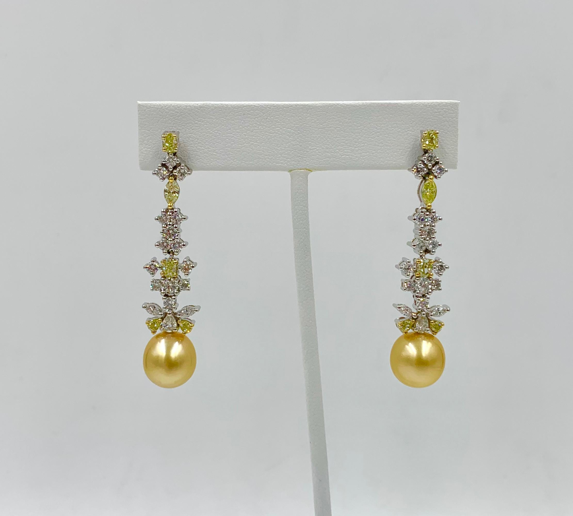 This is a magnificent pair of Four Carat Yellow Diamond, Diamond and Golden South Sea Pearl Pendant Dangle Earrings with 44 gorgeous diamonds set in 18 Karat White Gold.  The extraordinary earrings are a dramatic 2 1/8 inches long.  The earrings are