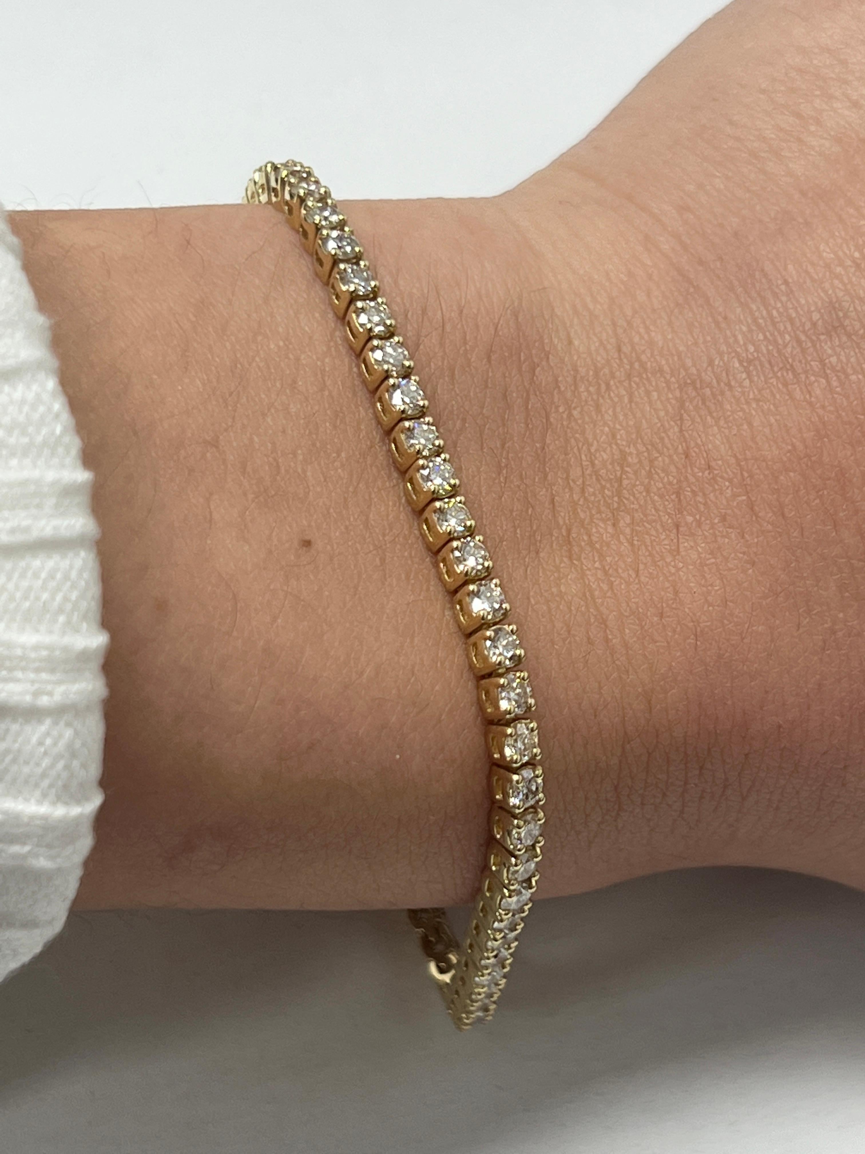 Fashion and glam are at the forefront with this exquisite diamond bracelet. This 14-karat yellow gold diamond bracelet is made from 10.3 grams of gold. The top is adorned with one row of I-J color, VS/SI clarity diamonds. This bracelet carries 63