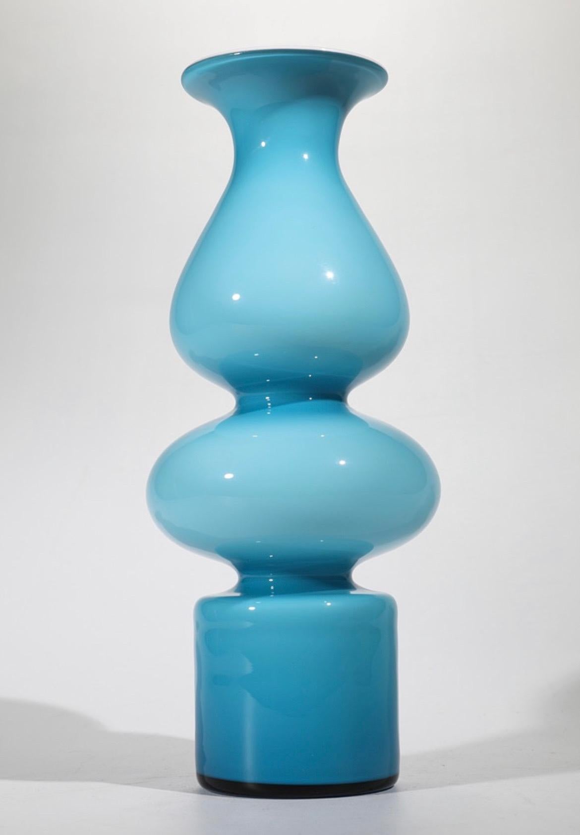 Set of 4 vases. Carnaby series. Per Lütken for Holmegaard. Light blue and red with white inner lining. In different shapes and sizes. 

Carnaby series from 1968 is one of Per Lütken (1916–1998) most beloved glass classics of the many designed he
