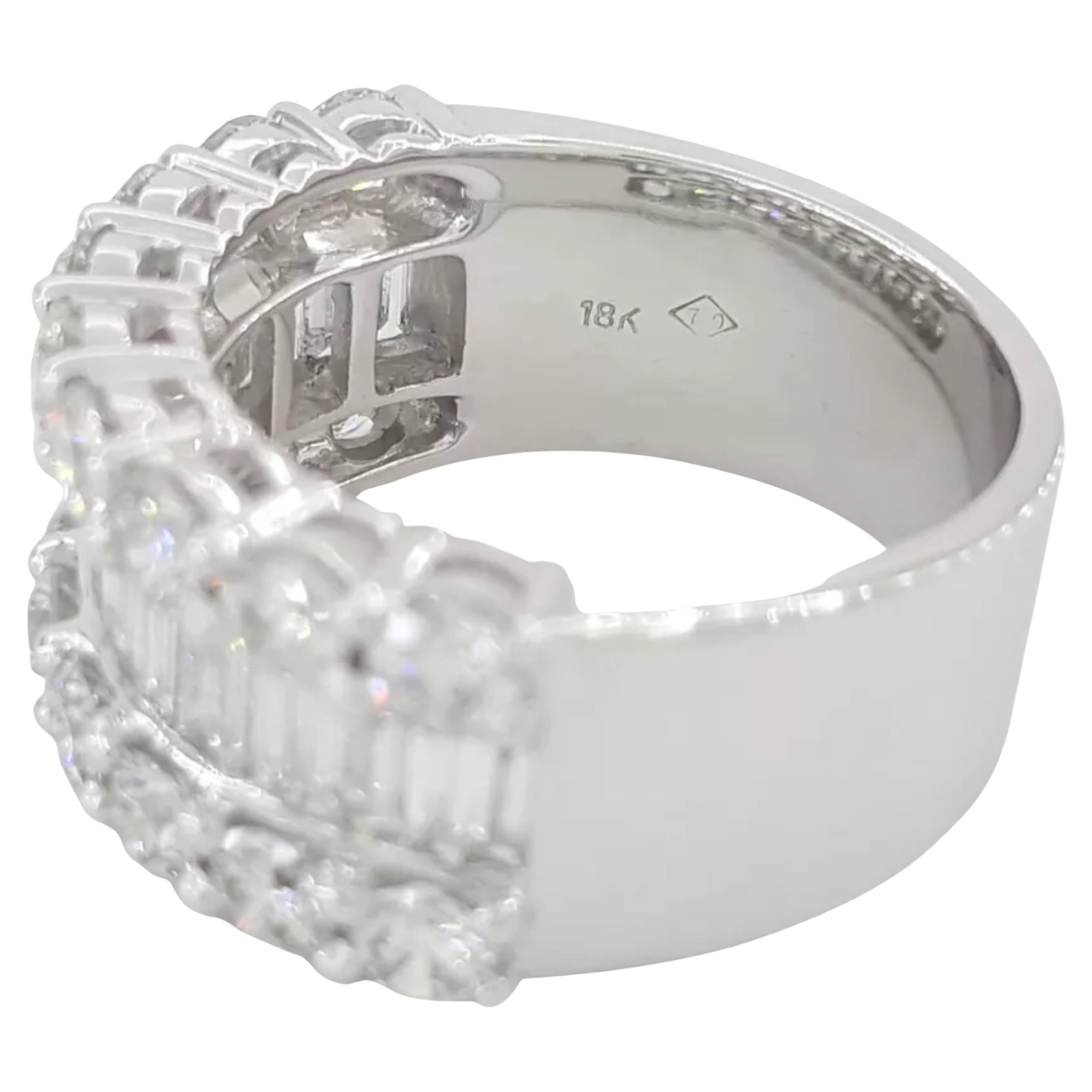 stunning wedding or anniversary band made of 18k white gold, weighing 12.1 grams. It is a size 7.5, fitting sizes 7-7.5 due to its wide width of 10.3 mm. The design features approximately 4 carats of diamonds, including 20 natural baguette diamonds