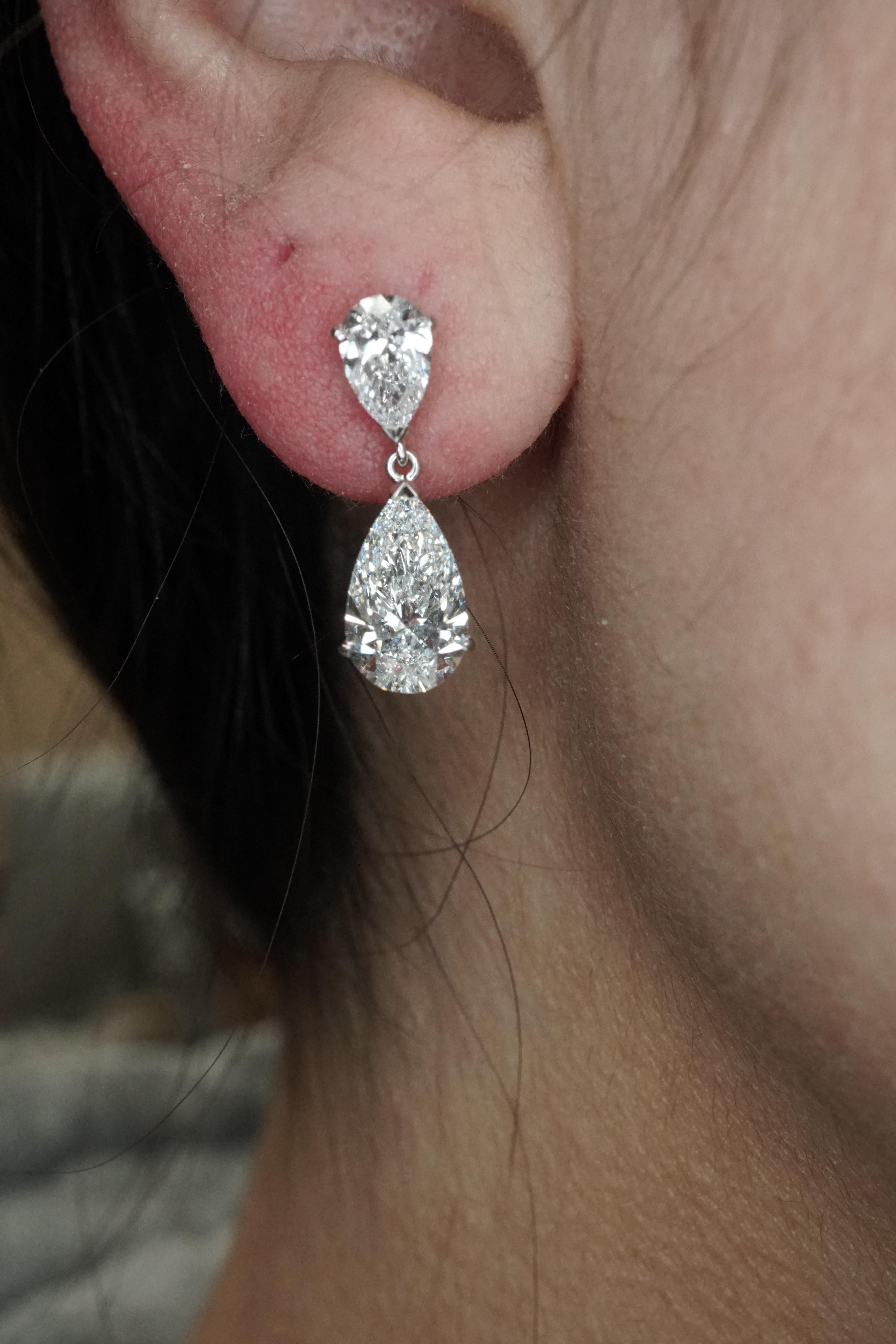 Alternating size pear cut diamond drop dangling earrings, 4 carats total weight 3.33 grams. These F VS2 diamonds are set in a 3 prong basket in platinum. This piece is customizable, price may vary depending on modifications such as, quality and