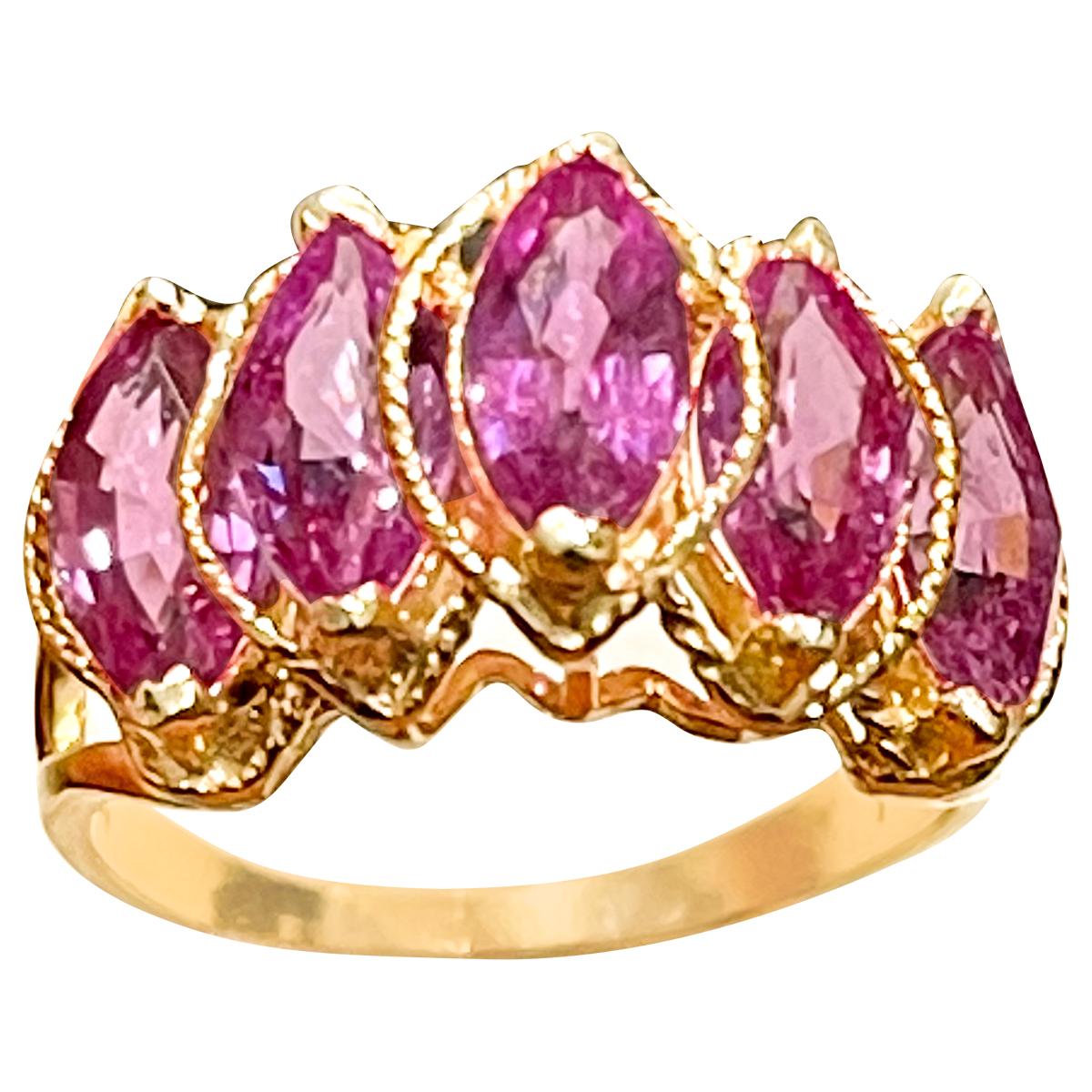 A classic, Band , Very delicate ring !
Approximately 4 Ct  Pink Sapphire &  Diamond 14 Karat Yellow  Gold Band Ring, Estate Size 6
5  natural Marquise shape  Pink sapphire 
14 Karat Yellow  Gold: 3.7  Grams
 Stamped  for 14 K Gold
Ring Size 6  ( can