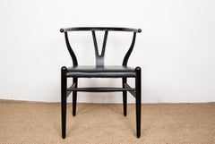 4 Danish chairs, in black lacquered wood and leather, model CH 24 by Hans Wegner