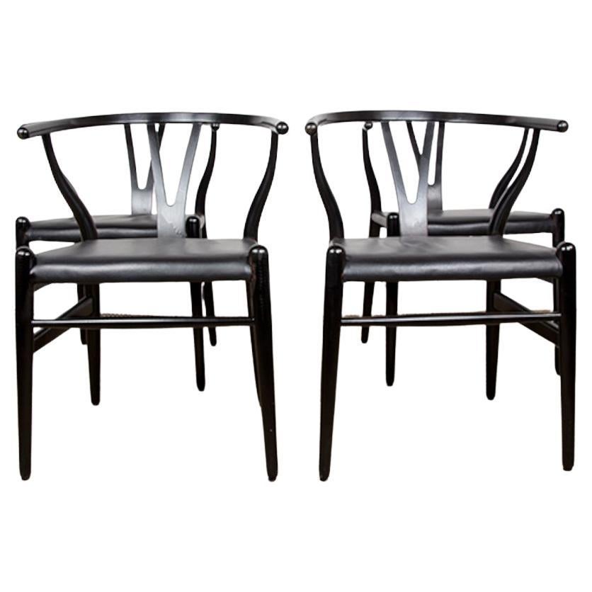 4 Danish chairs, in black lacquered wood and leather, model CH 24 by Hans Wegner For Sale