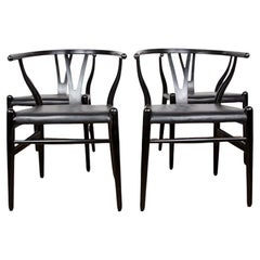 4 Danish chairs, in black lacquered wood and leather, model CH 24 by Hans Wegner