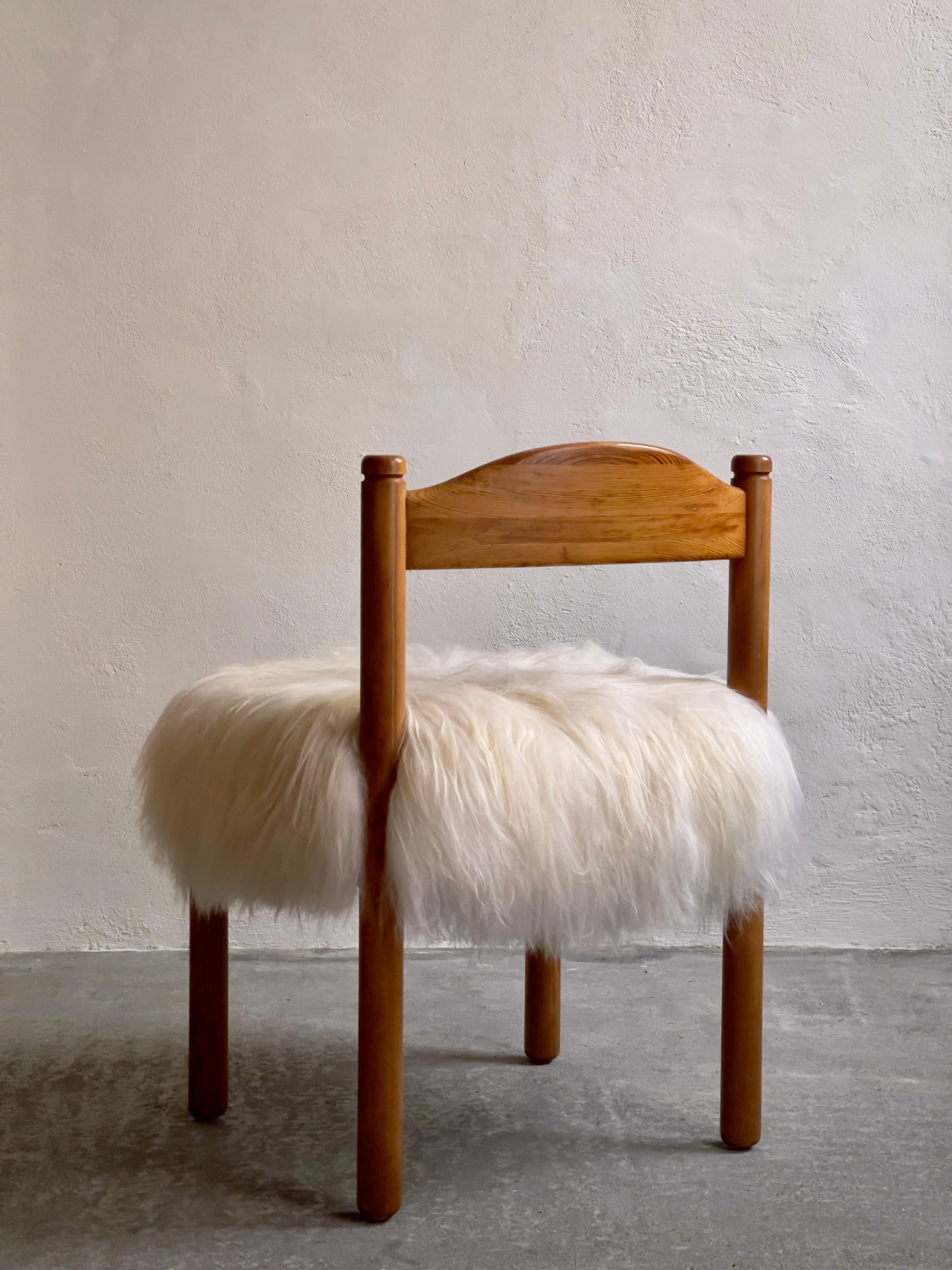 A set of 4 danish dining chairs in patinated pine and  reupholstered long haired Icelandic sheepskin. (Price is for all 4 chairs)
These 1970s chairs are expertly fashioned from patinated pine wood, which carries the allure of age. A hallmark of