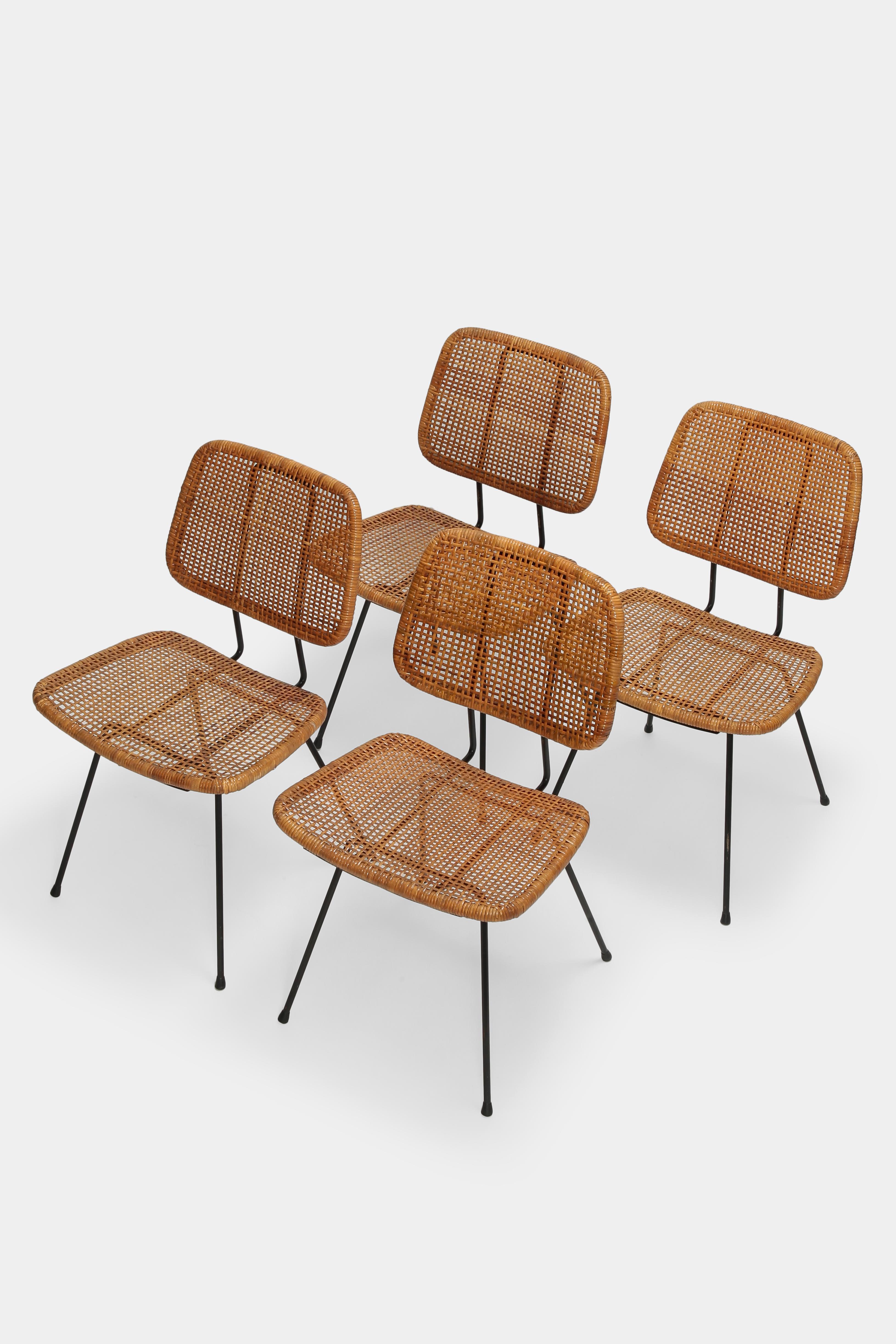 4 Dirk van Sliedregt Chairs 550 designed in the 1950s and manufactured by Rohé Noordwolde in the Netherlands. High quality wickerwork seat and backrest with a black lacquered metal base. Partly restored recently and in a great condition with a