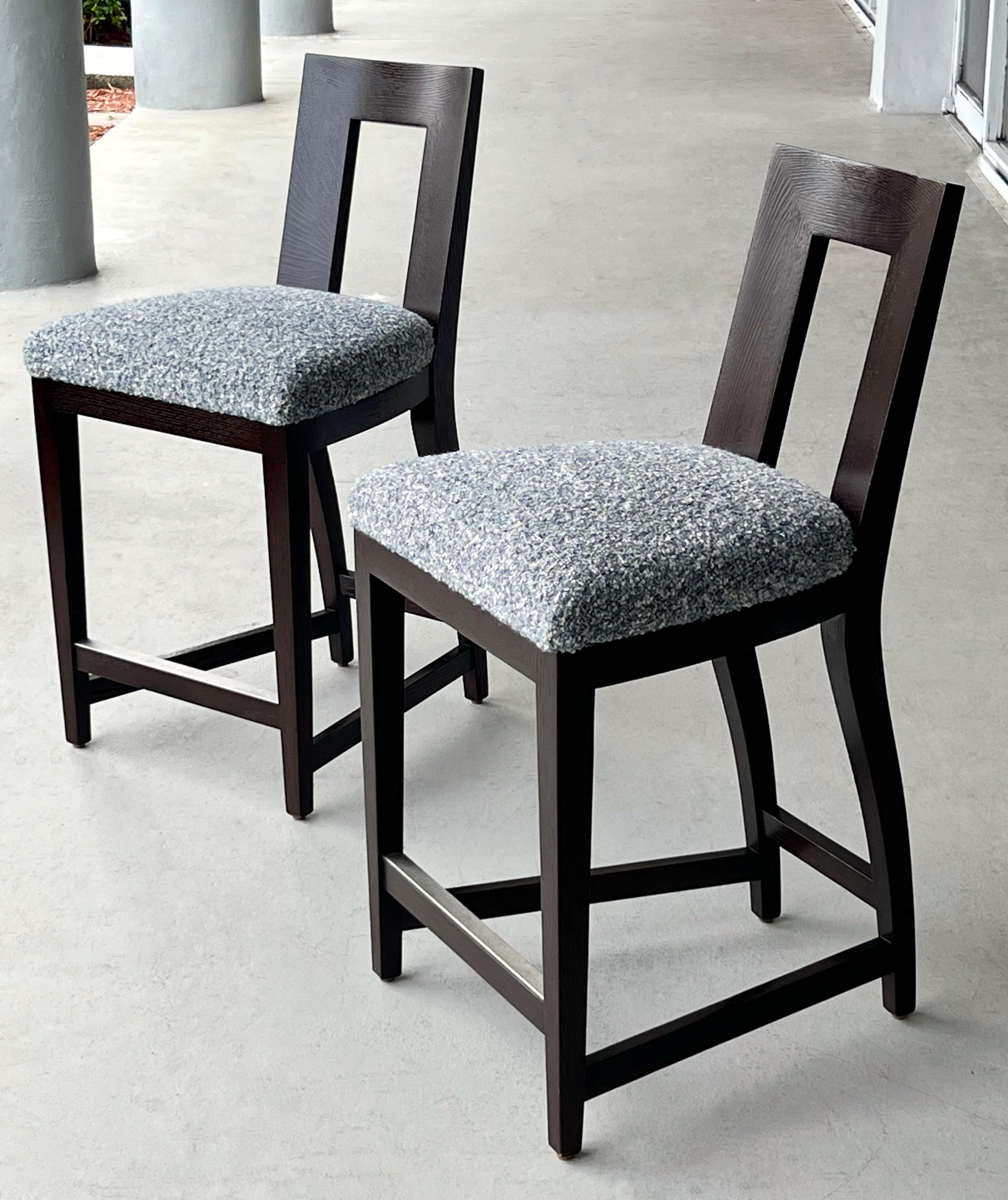 A set of four elegant  stools by Donghia, executed in an Ebonized oak frame and boucle upholstered seat. The pieces reflect the brand’s signature blend of classic craftsmanship and modern sensibility.
	•	Solid oak construction throughout the