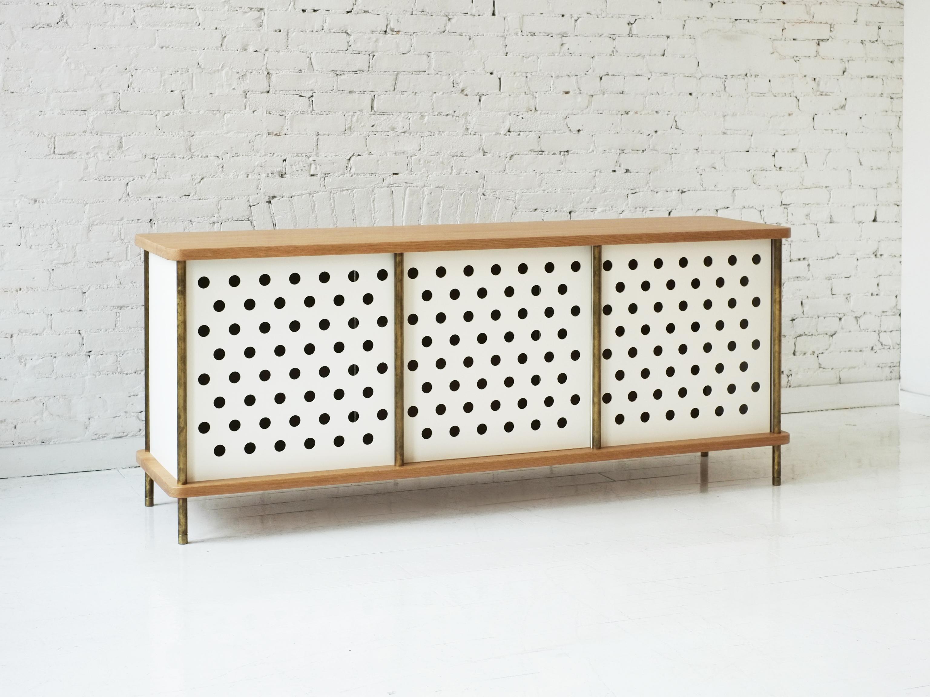 Consistent with the Strata collection, the new Strata Credenza is designed to be modular in order to create versatile configurations tailored to your needs. Immediately available as shown with brass rods, walnut top and four powder coated aluminum