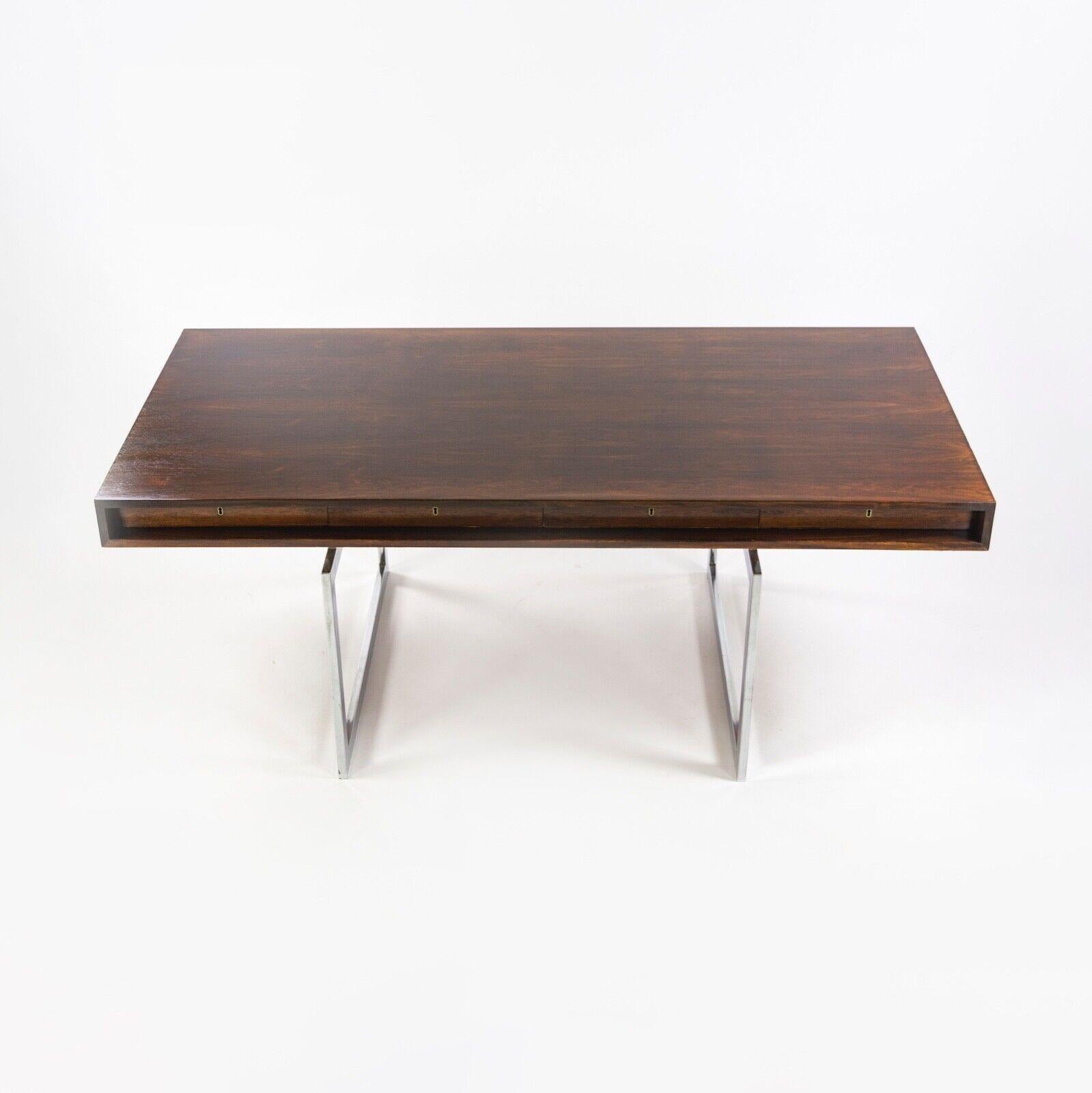 We present a very nice example of the 4-Drawer Bodil Kjaer Desk for E. Pedersen & Son, finished in Brazilian rosewood. The table has been freshly oiled. There are some signs of wear from the past 50-60 years of use. Some wear is noted near the