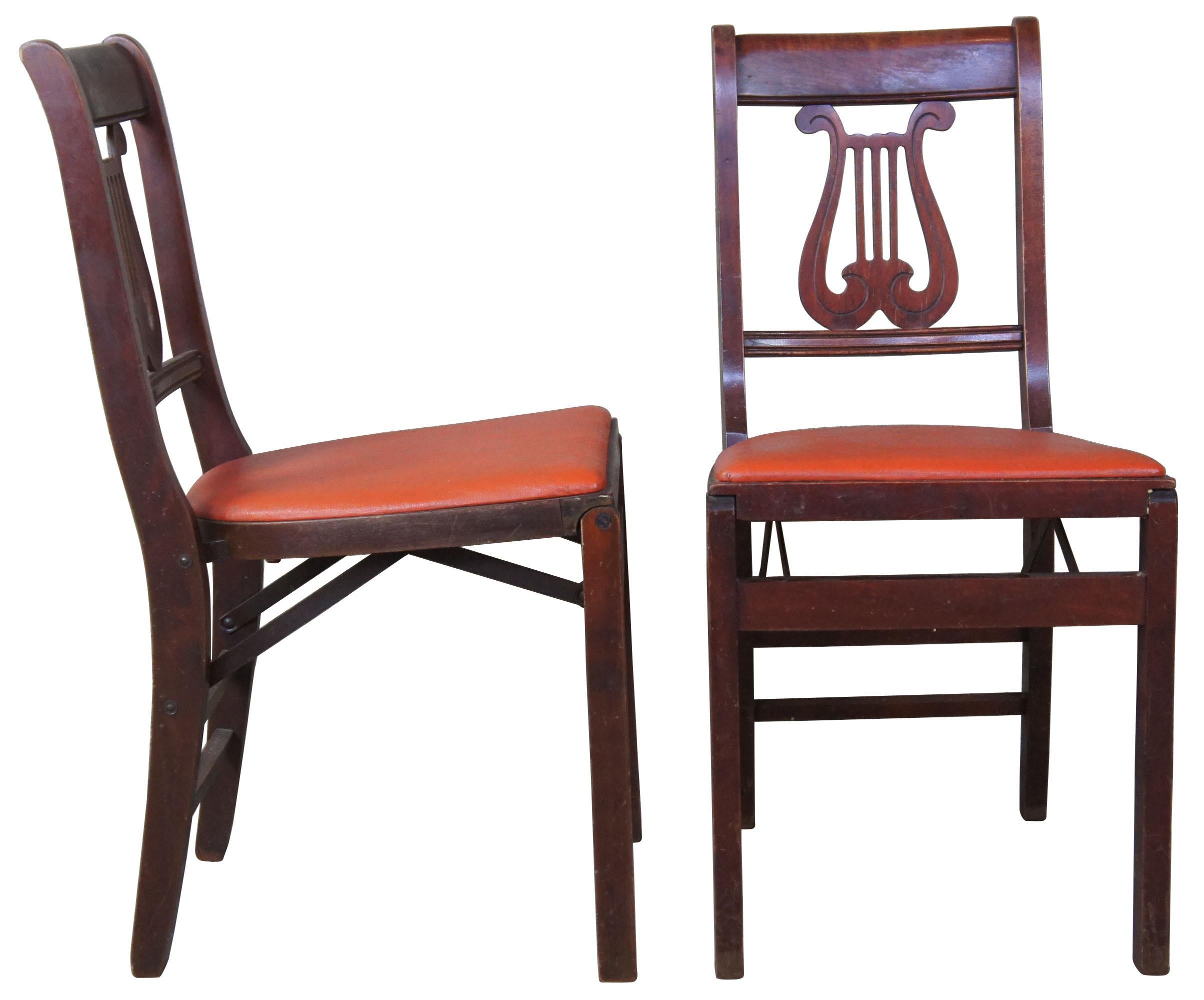 Four Mid-Century Modern folding stackable chairs by Stakmore furniture of New York. Features a wood frame and orange vinyl seats. Stakmore, the Aristocrats of Folding Furniture.

Measure: Depth folded - 6
