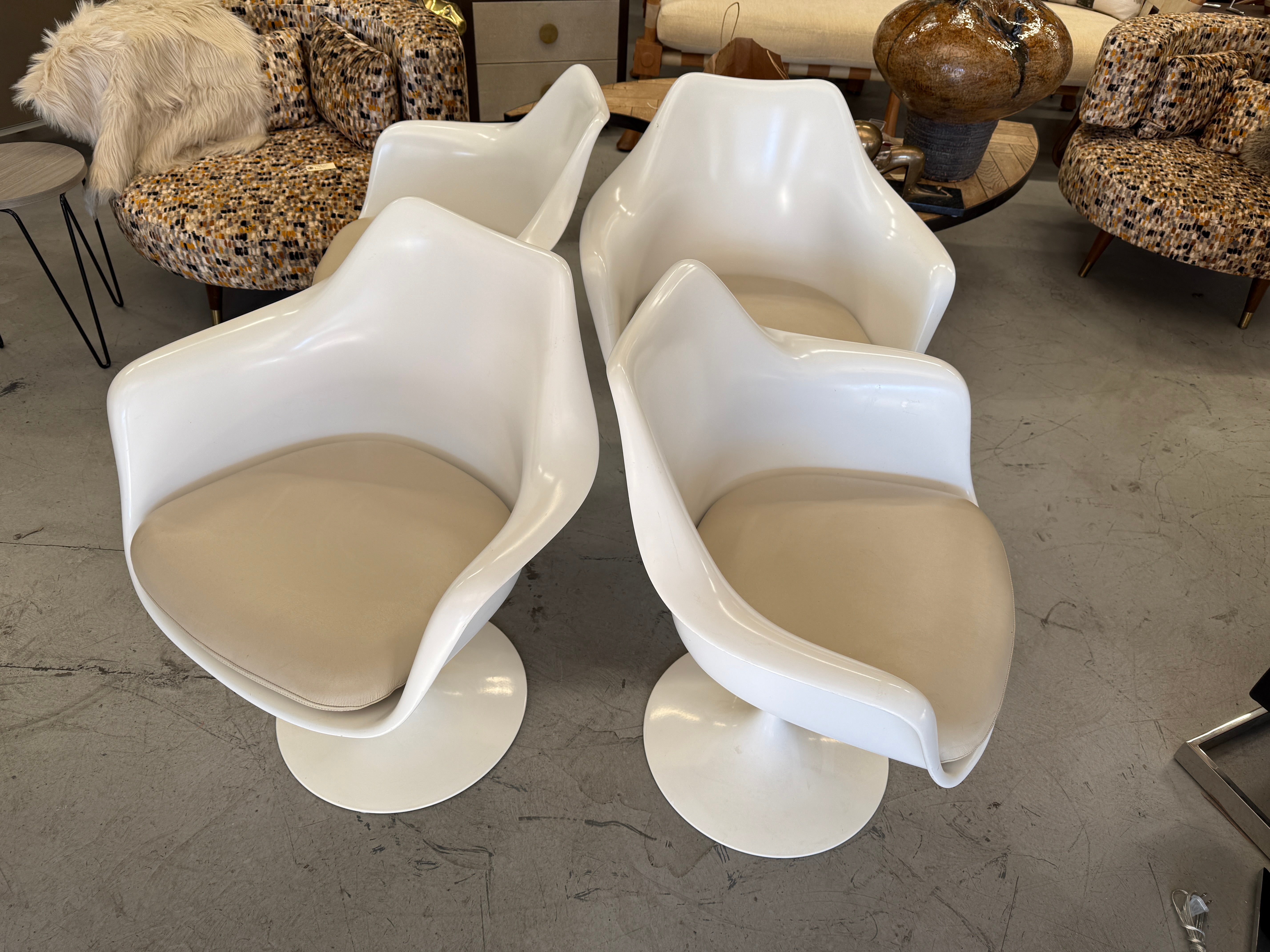 A nice set of 4 Eero Saarinen tulip armchairs for Knoll.  These are the swivel version and have the leather cushions. This is the most expensive version Knoll sells of this chair. These are from the early 2000’s we believe. Acquired out of a local
