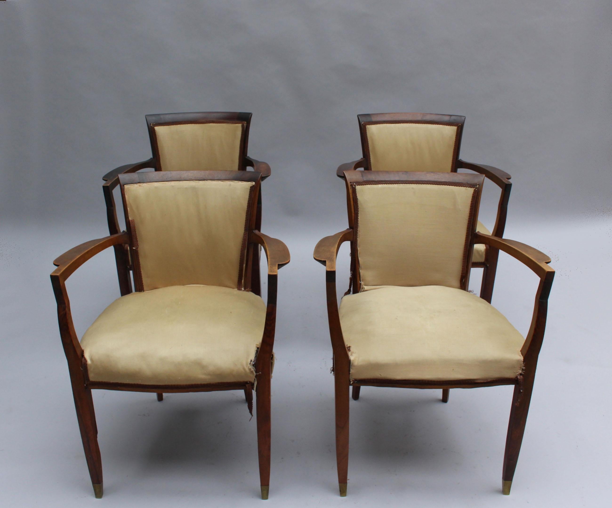 Four fine French Art Deco walnut bridge armchairs by Jules Leleu with bronze sabots.
Documented.
Price is per chair.
