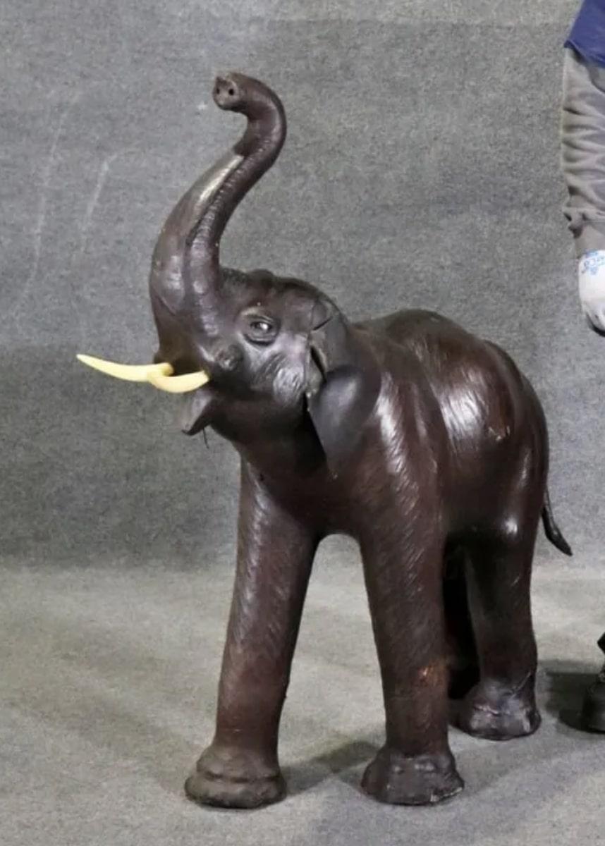 Leather wrapped sculpture of an elephant shows great detail with eyes, ears and tusks.
Please confirm location NY or NJ