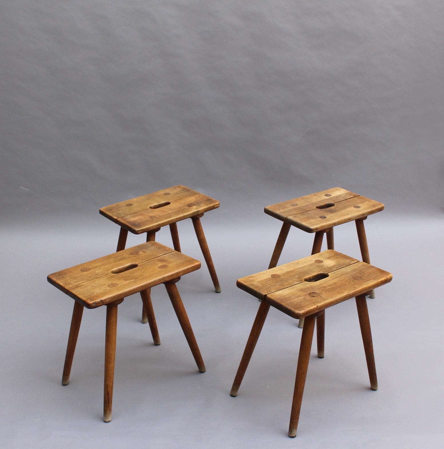 Four French Mid-Century beech wood stools or occasional tables.