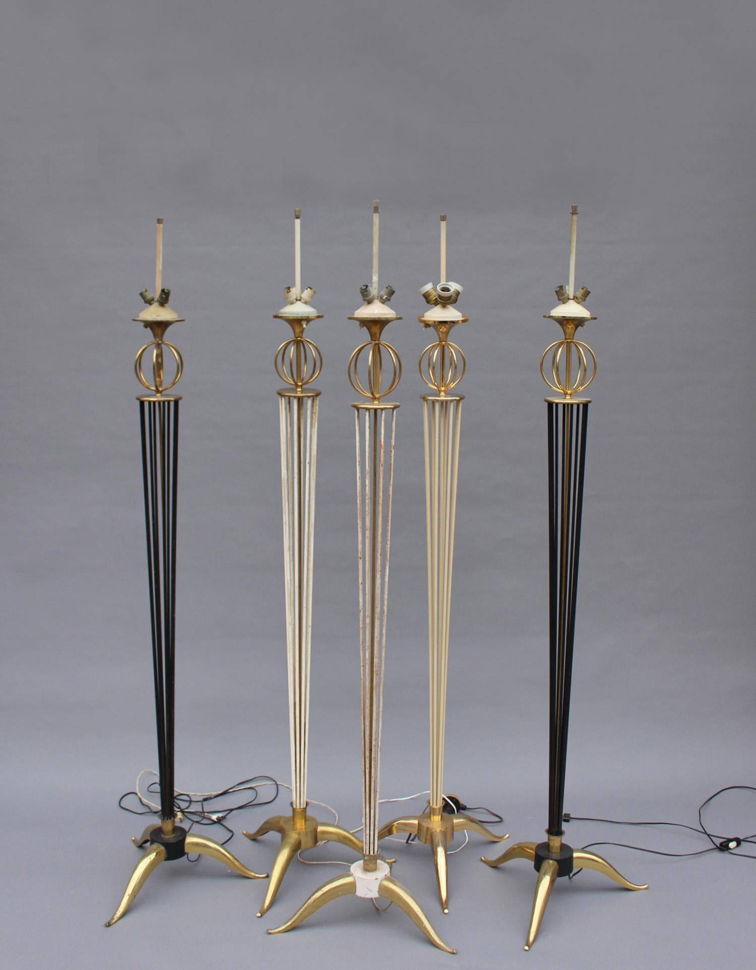 Five French mid-century brass and painted metal floor lamps by Arlus.