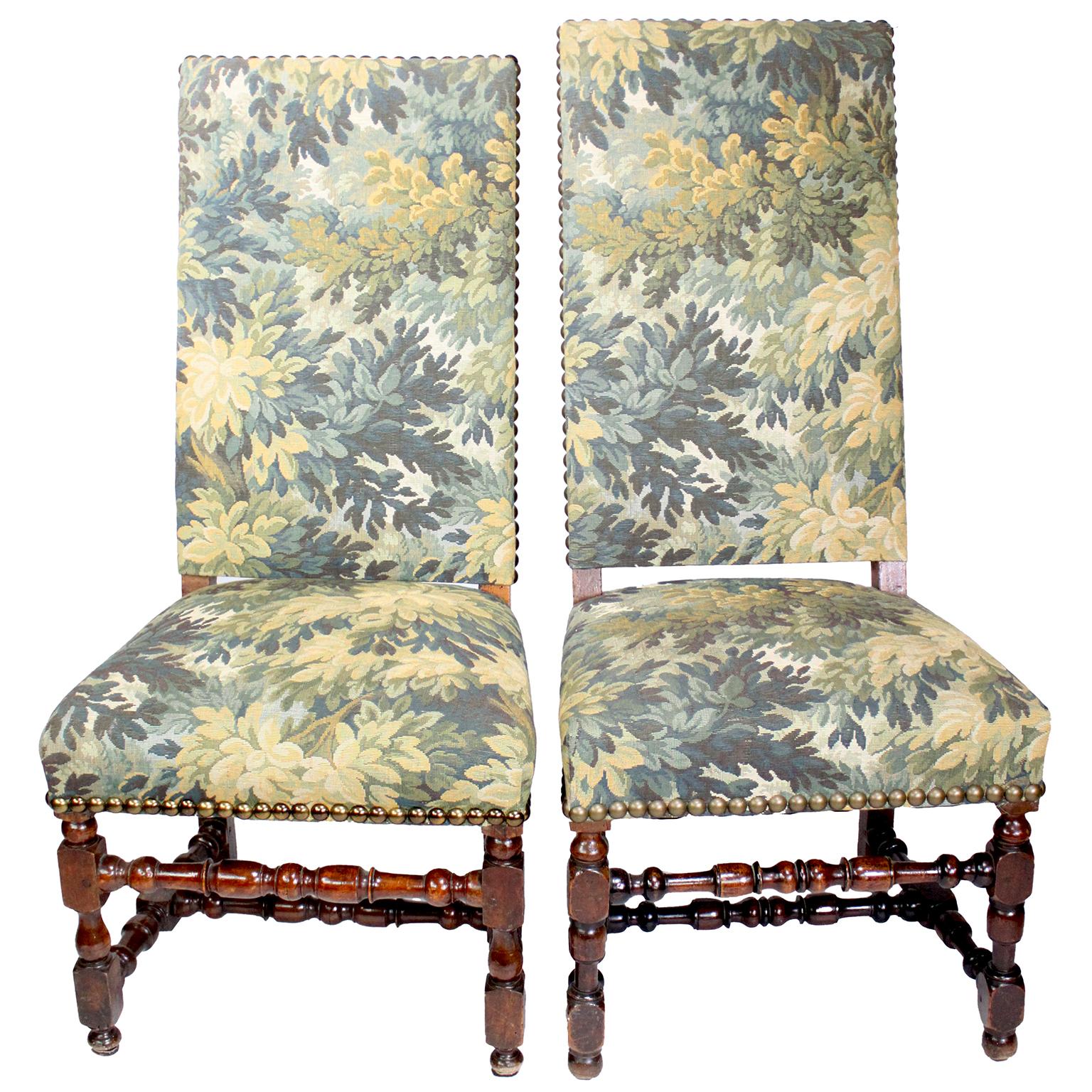 An Assembled Set of Four French 19th-20th Century Baroque Revival Walnut Carved and Verdure Tapestry Side Chairs. The high-back upholstered frames in a Verdure floral tapestry, raised of four conjoined tooled carved legs. Circa: 1900.

Note: One