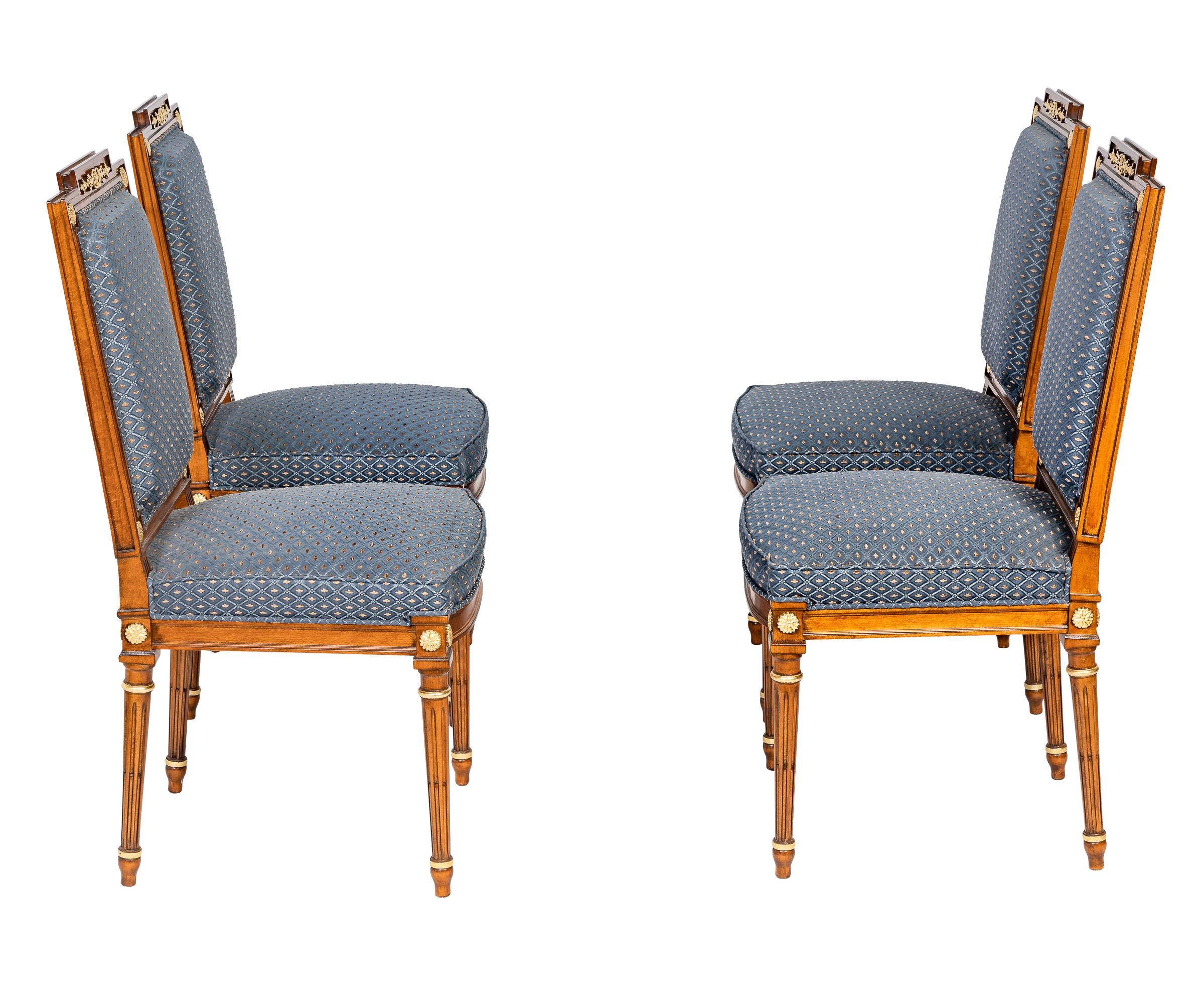 These exquisite French 19th century Louis XVI style dining chairs are handmade and carved in Italy.
The carvings of the armchairs are filigree and decorated with gold ornaments on the front and back. Floral details and an ornament on the top show